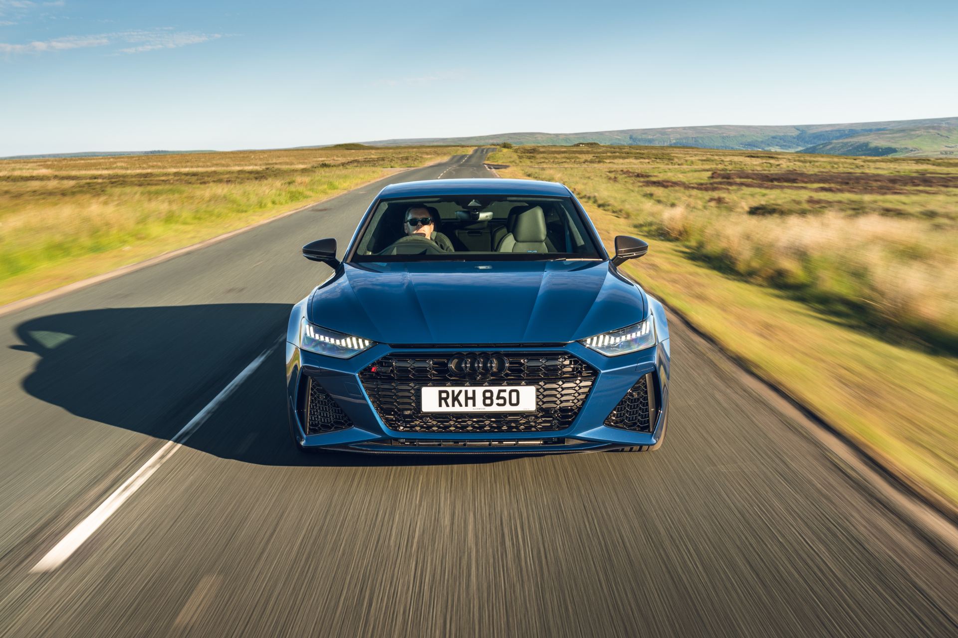 2025 audi rs 7 sportback performance driving front moorland road blue