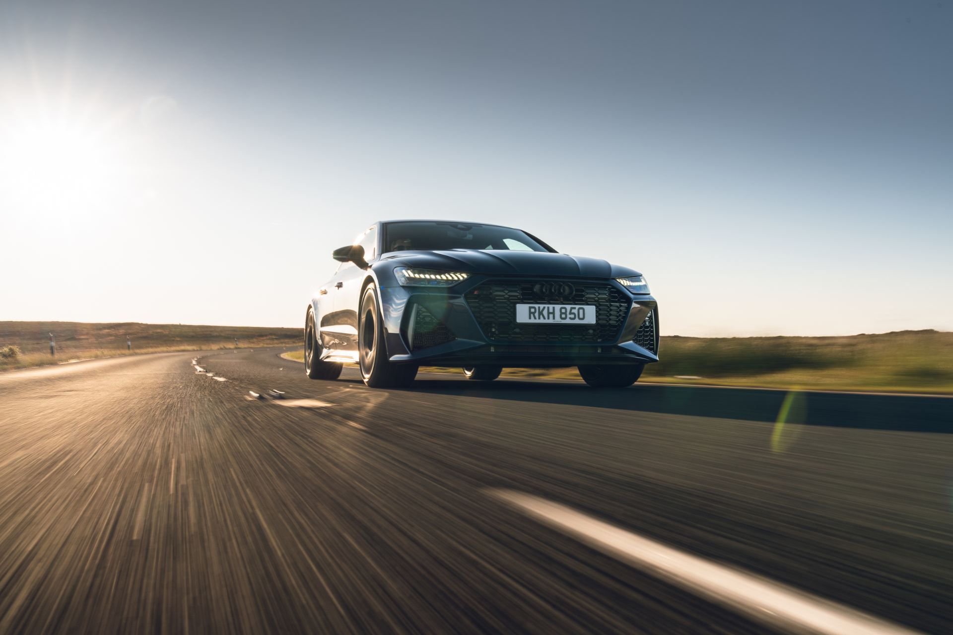 2025 audi rs 7 sportback performance driving front three quarter low sun blue