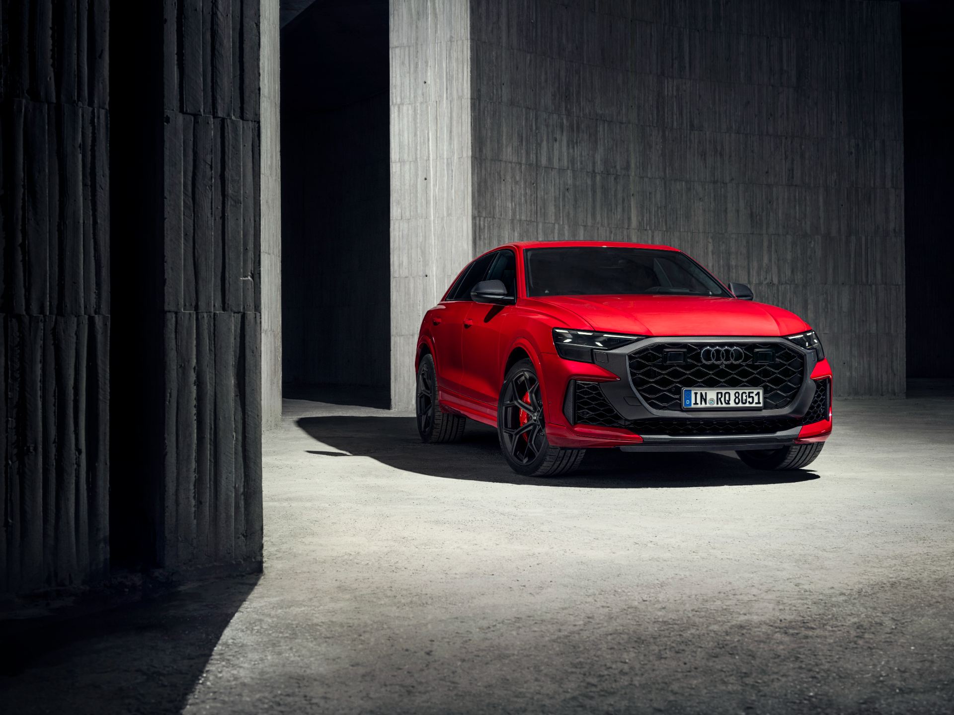 2027 audi rs q8 performance front three quarter concrete columns red