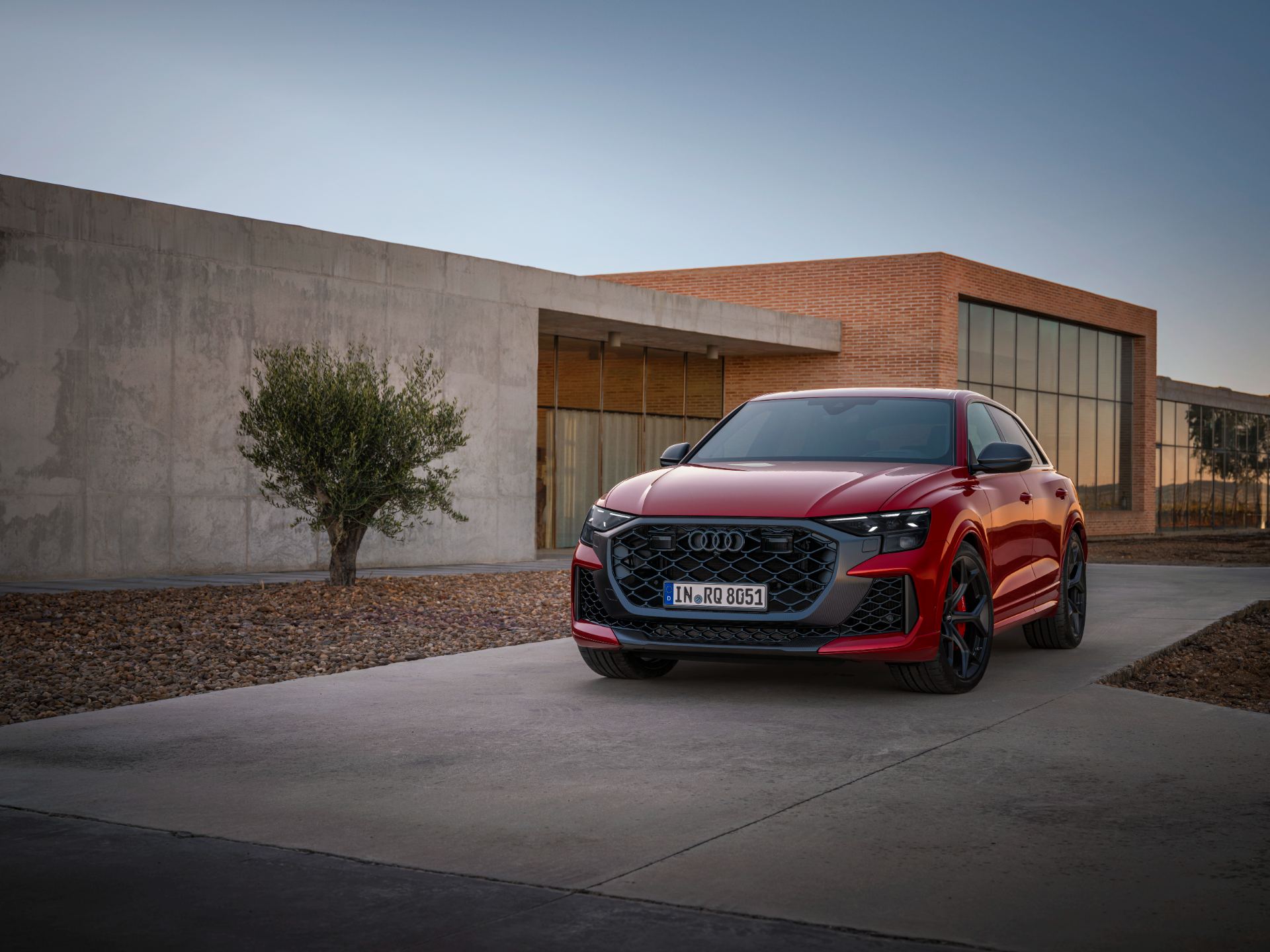 2027 audi rs q8 performance front three quarter modern building red