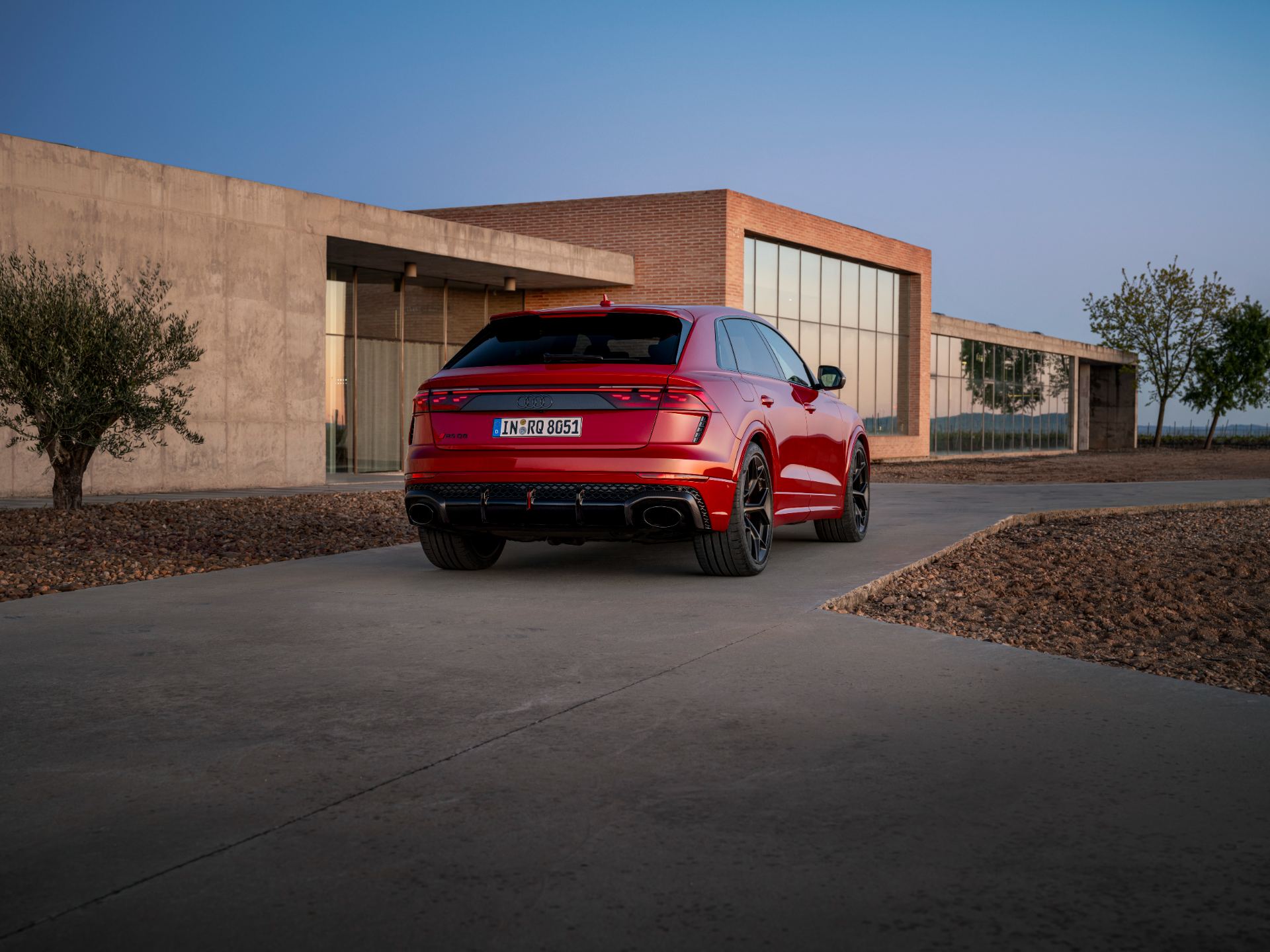 2027 audi rs q8 performance rear three quarter modern building red