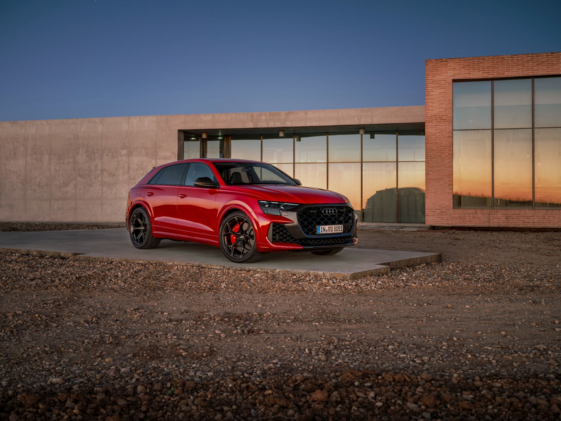 2027 audi rs q8 performance front three quarter building sunset red