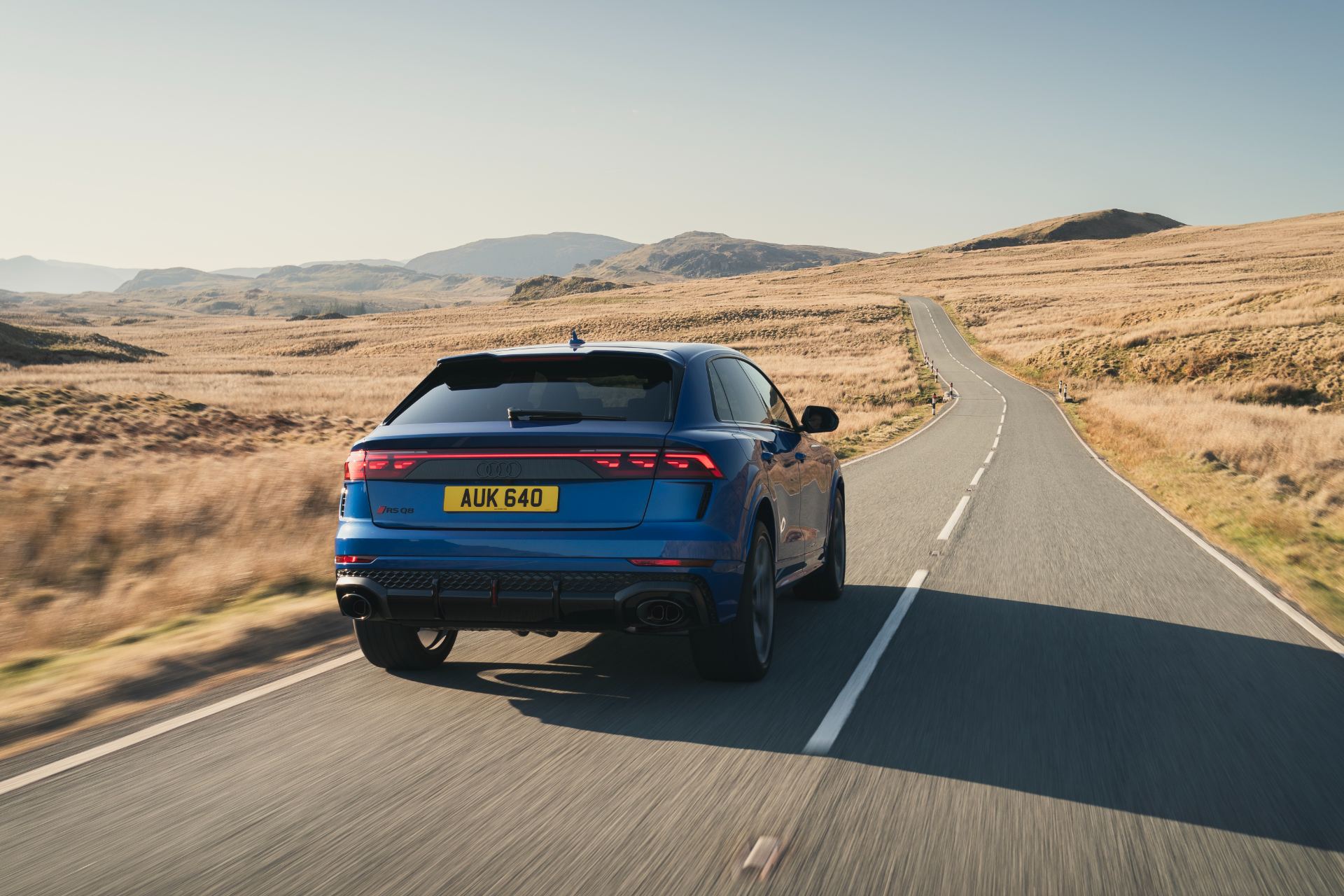 2026 audi rs q8 performance driving rear mountain road blue