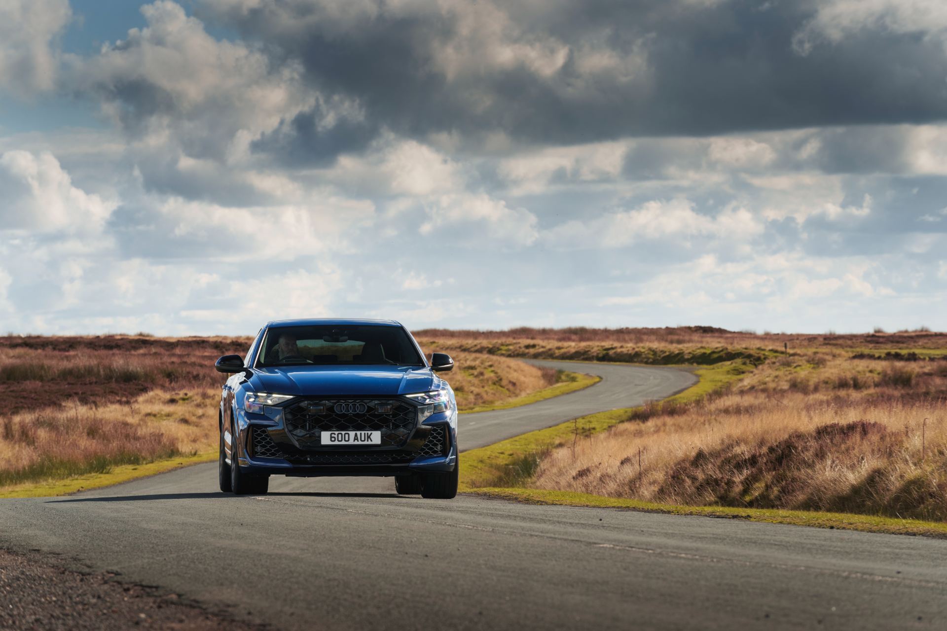 2026 audi rs q8 driving front winding road blue