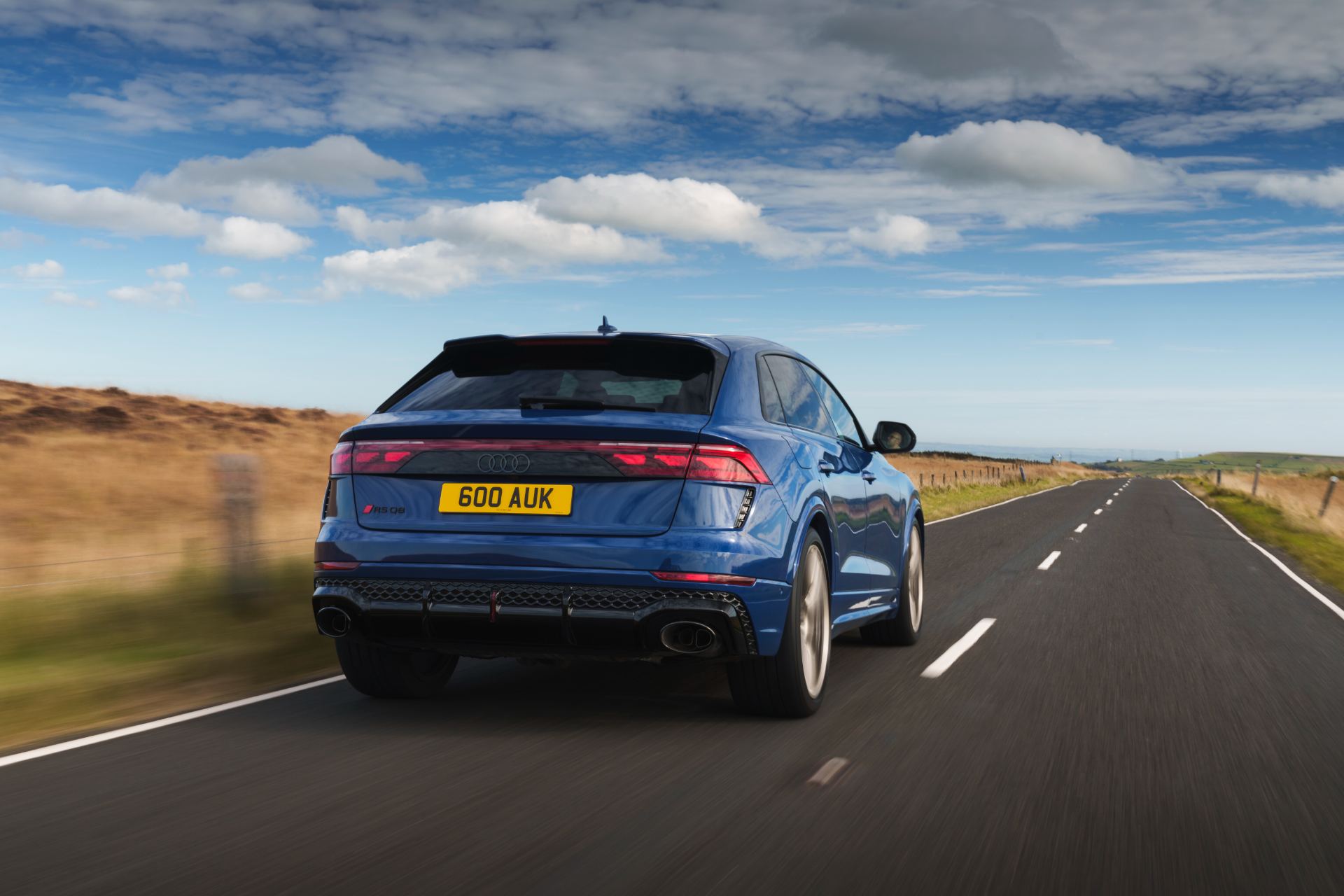 2026 audi rs q8 driving rear three quarter blue