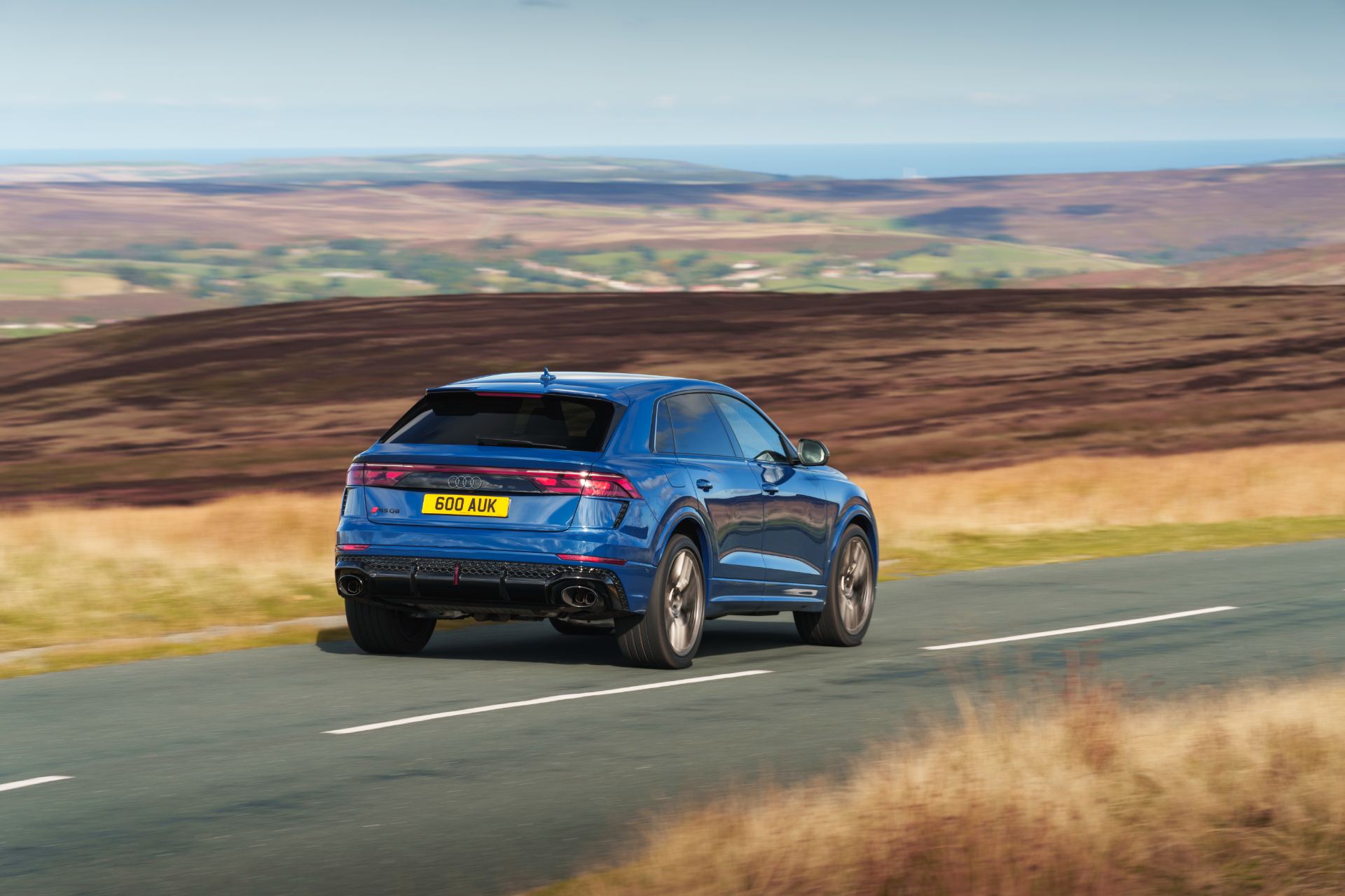 2026 audi rs q8 driving rear three quarter moorland blue