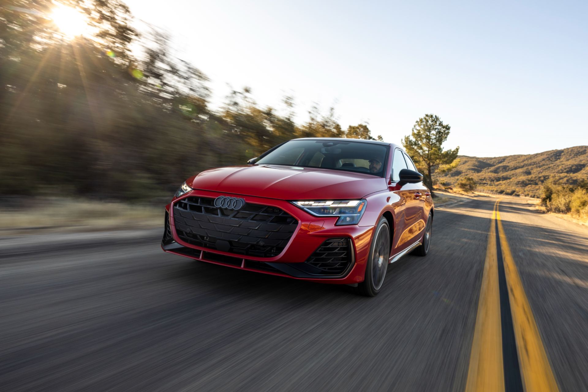 2026 audi s3 driving front three quarter sunlight red