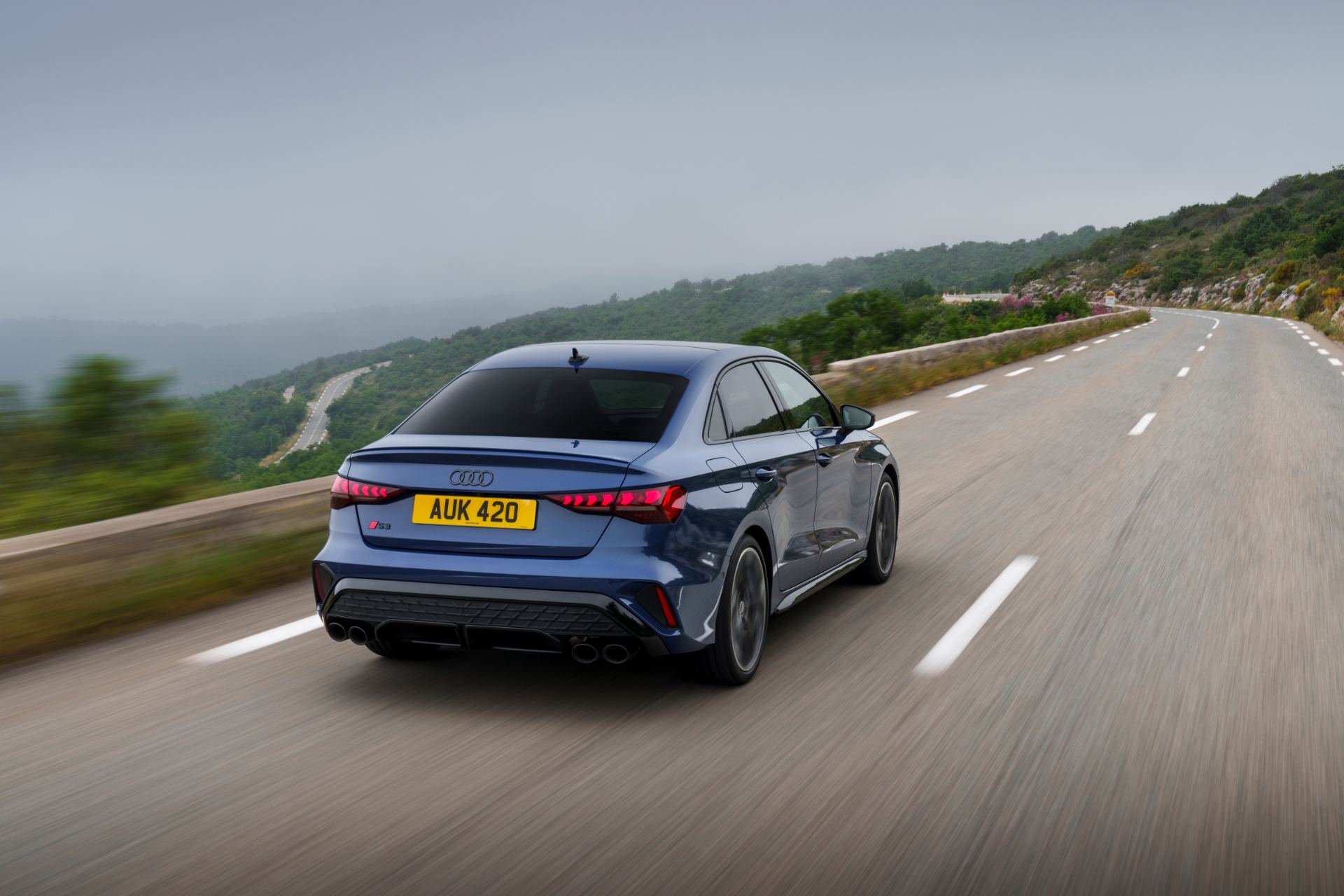 2025 audi s3 saloon driving rear mountain road blue