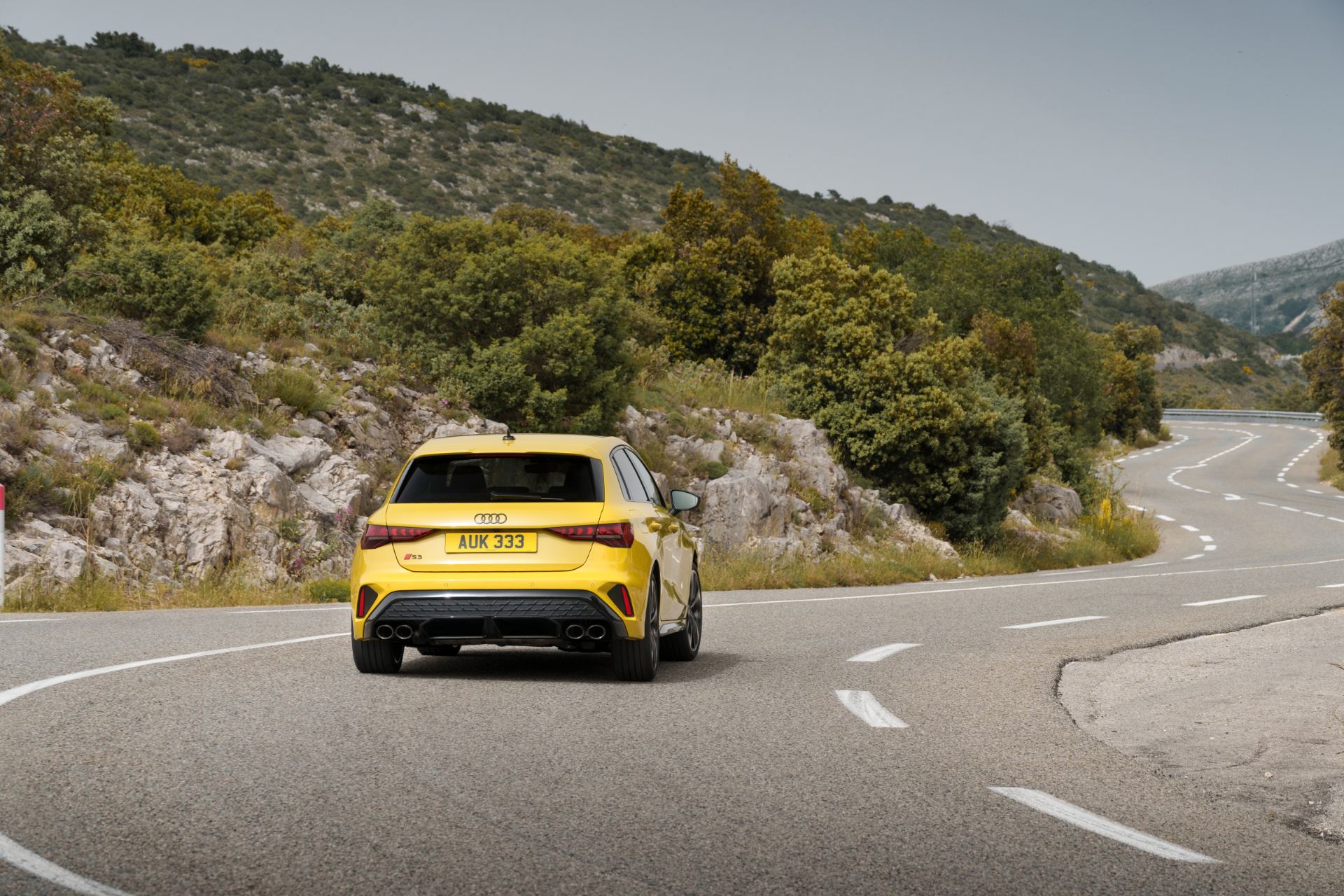 2025 audi s3 sportback driving rear winding road yellow
