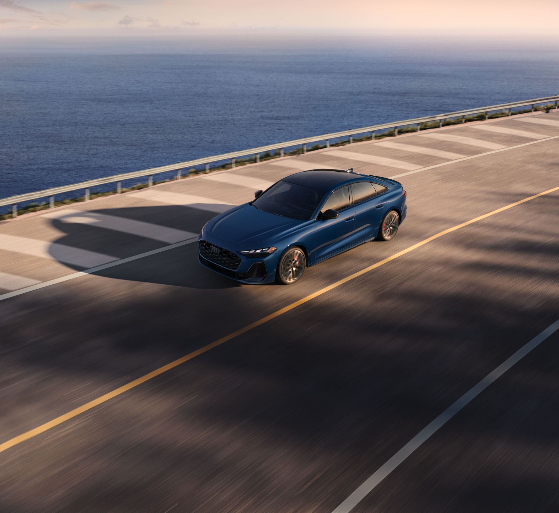2026 audi s5 driving front high angle coast blue