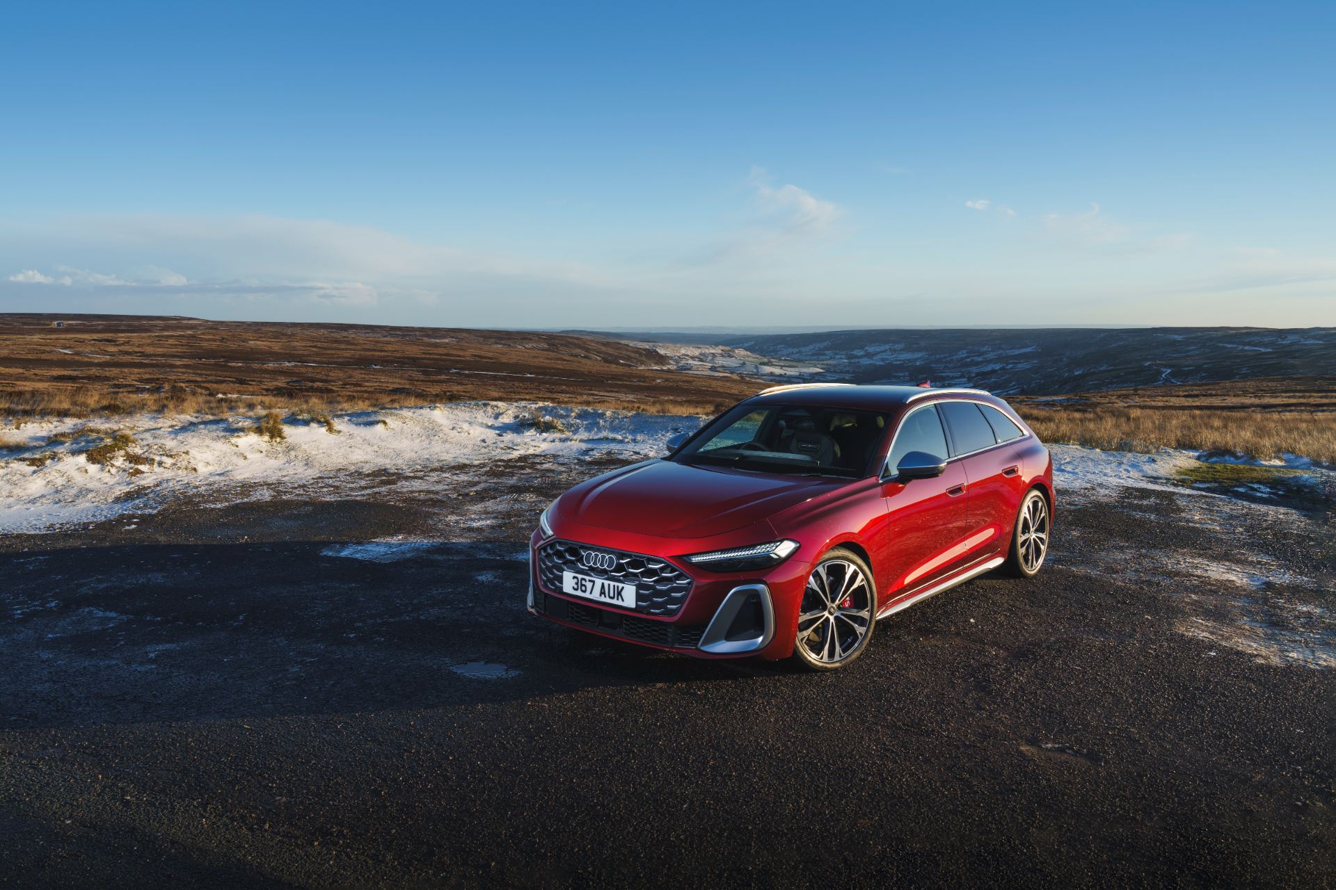 2026 audi s5 avant front three quarter snowy moorland red