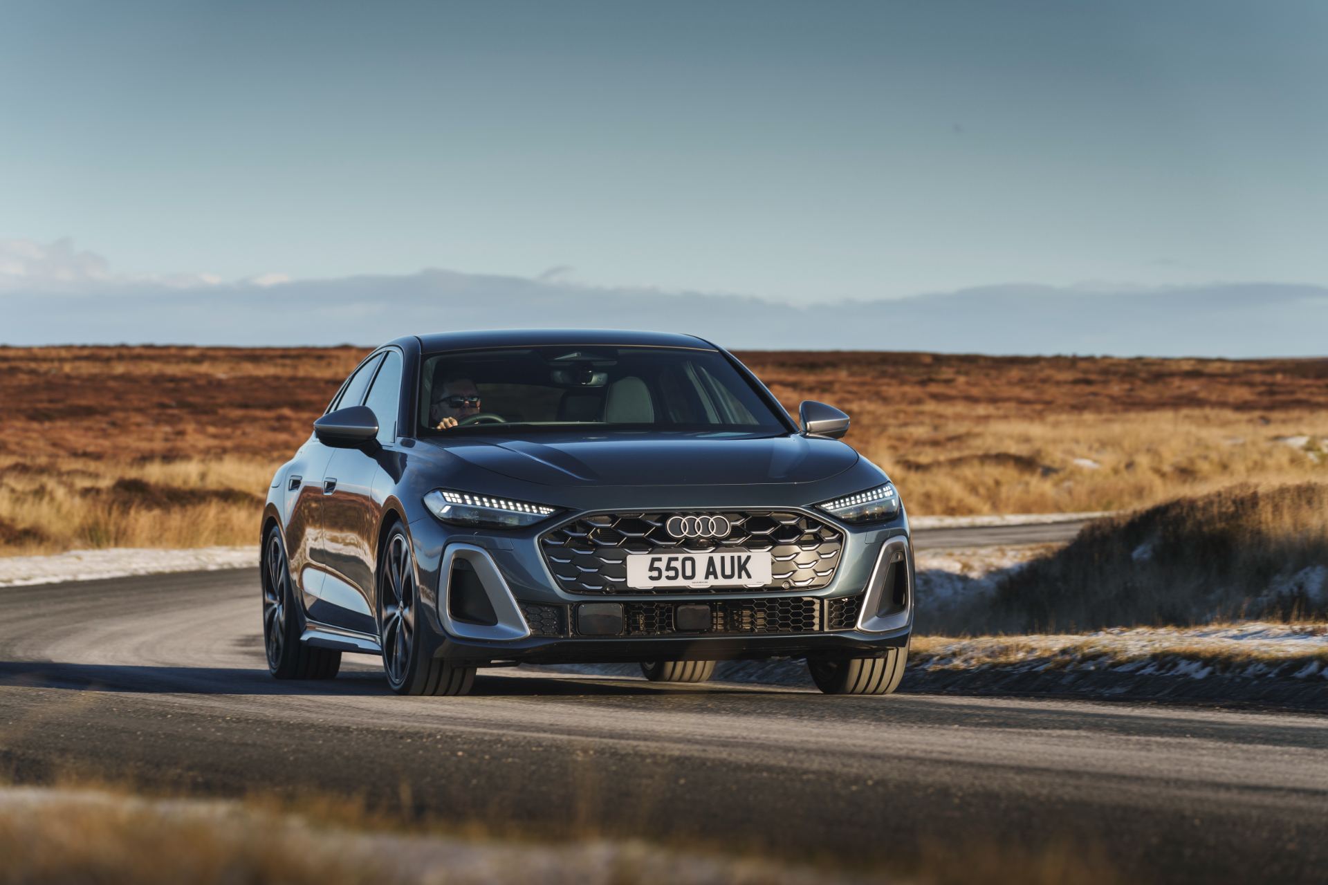 2026 audi s5 saloon driving front moorland road grey