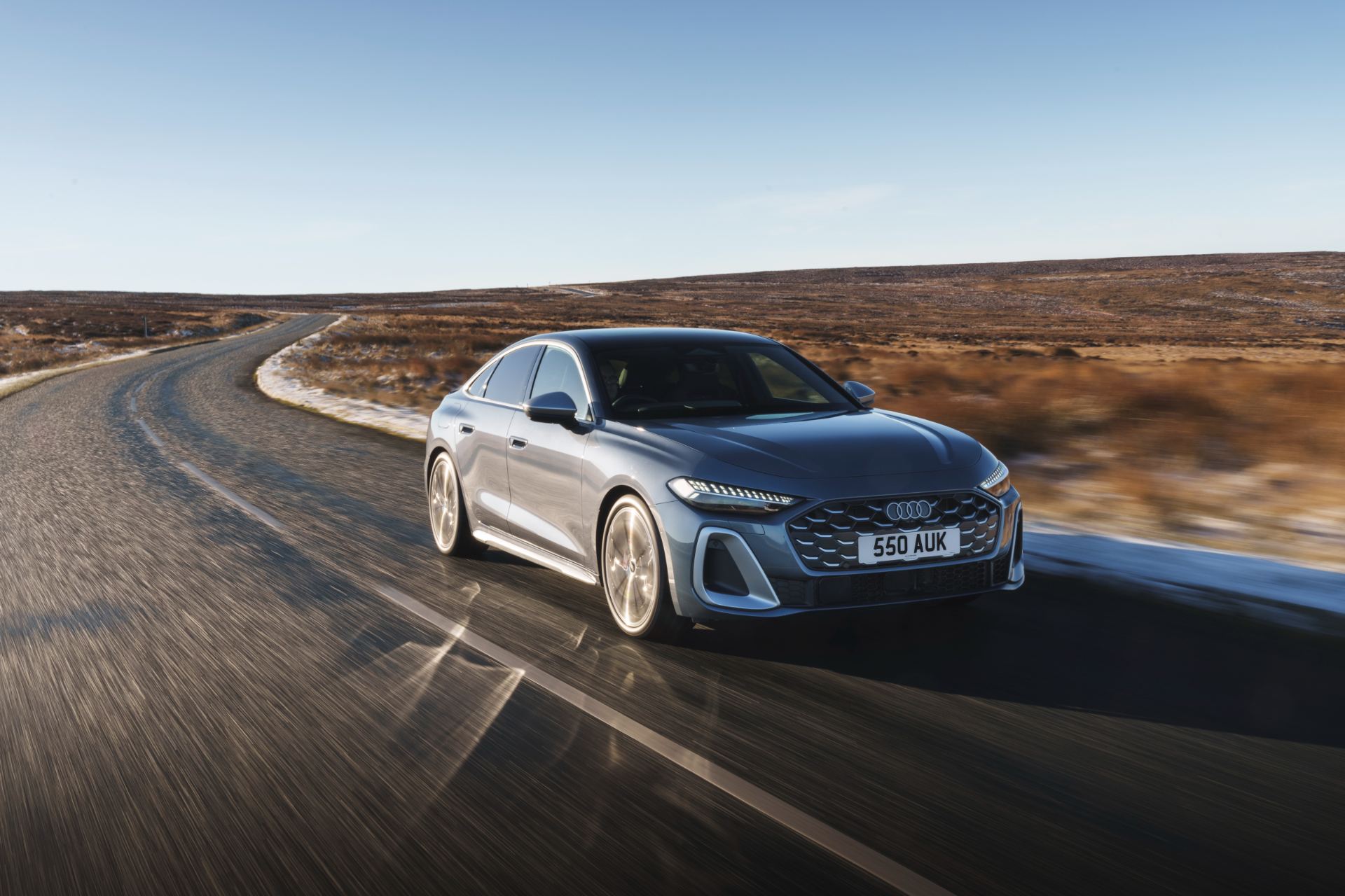 2026 audi s5 saloon driving front three quarter moorland road grey