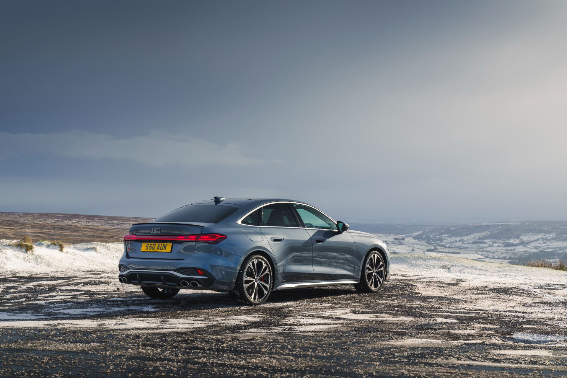 2026 audi s5 saloon rear three quarter snowy moorland grey