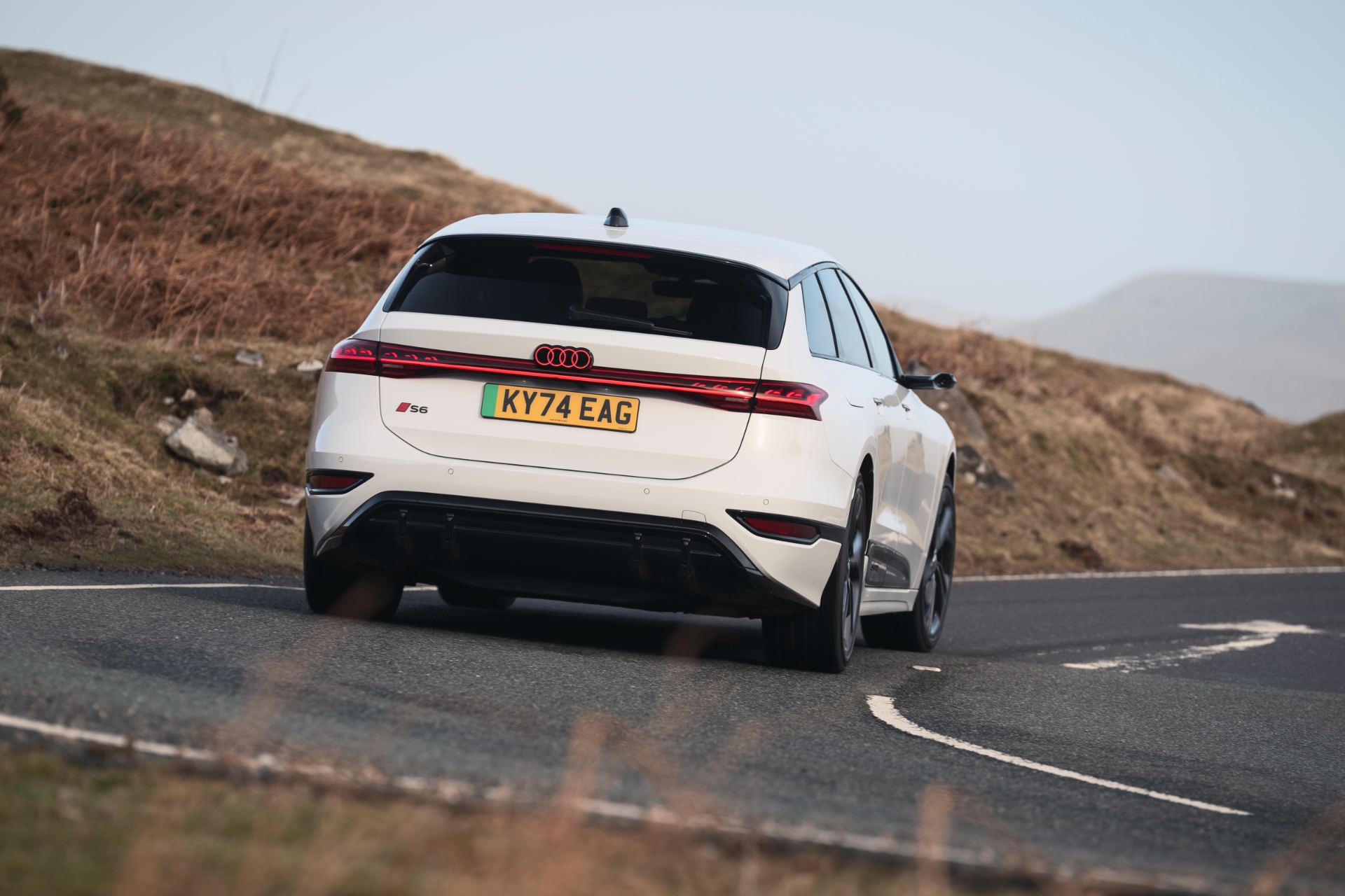 2026 audi s6 avant e tron driving rear three quarter bend white