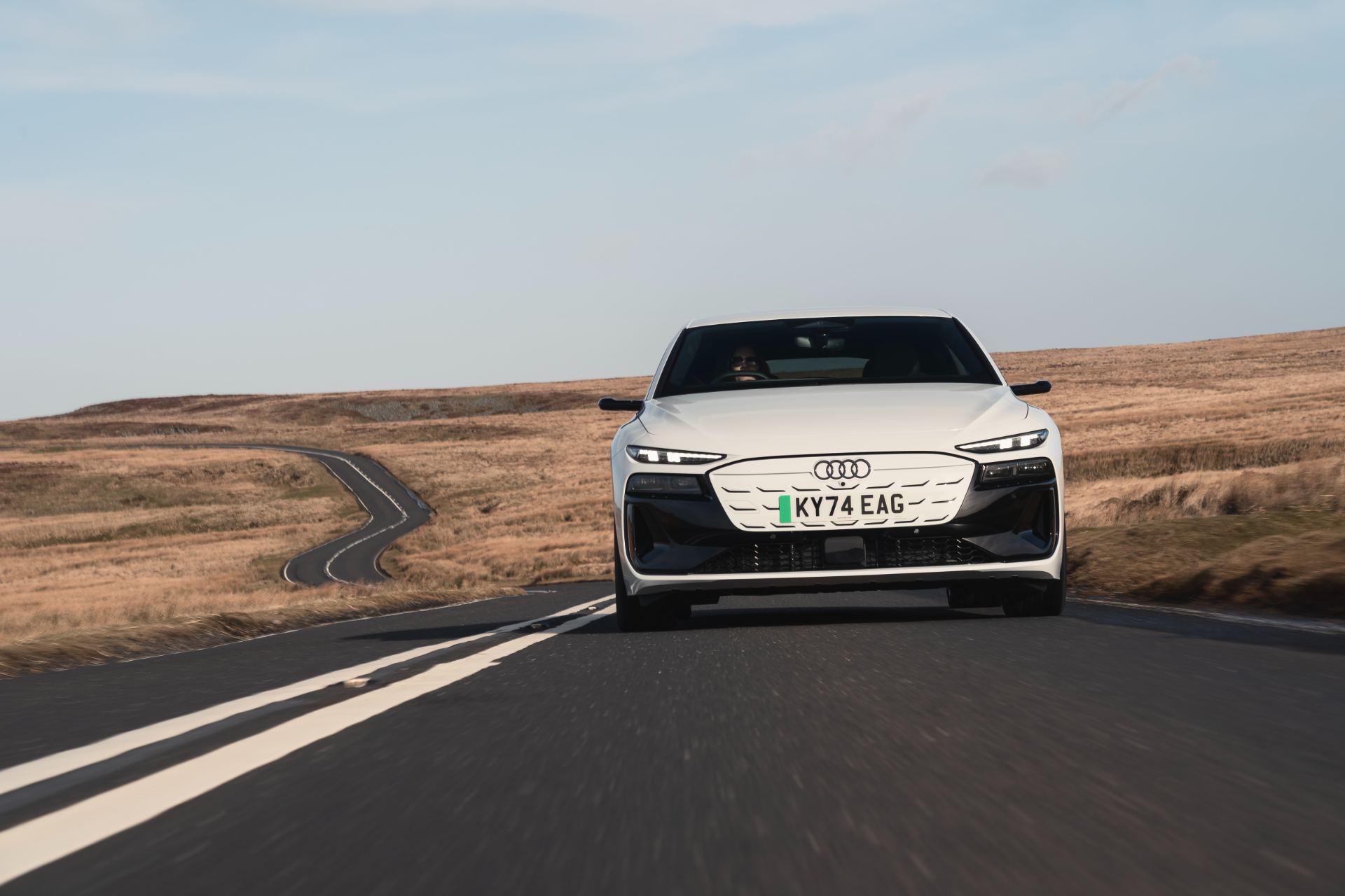2026 audi s6 avant e tron driving front moorland road white