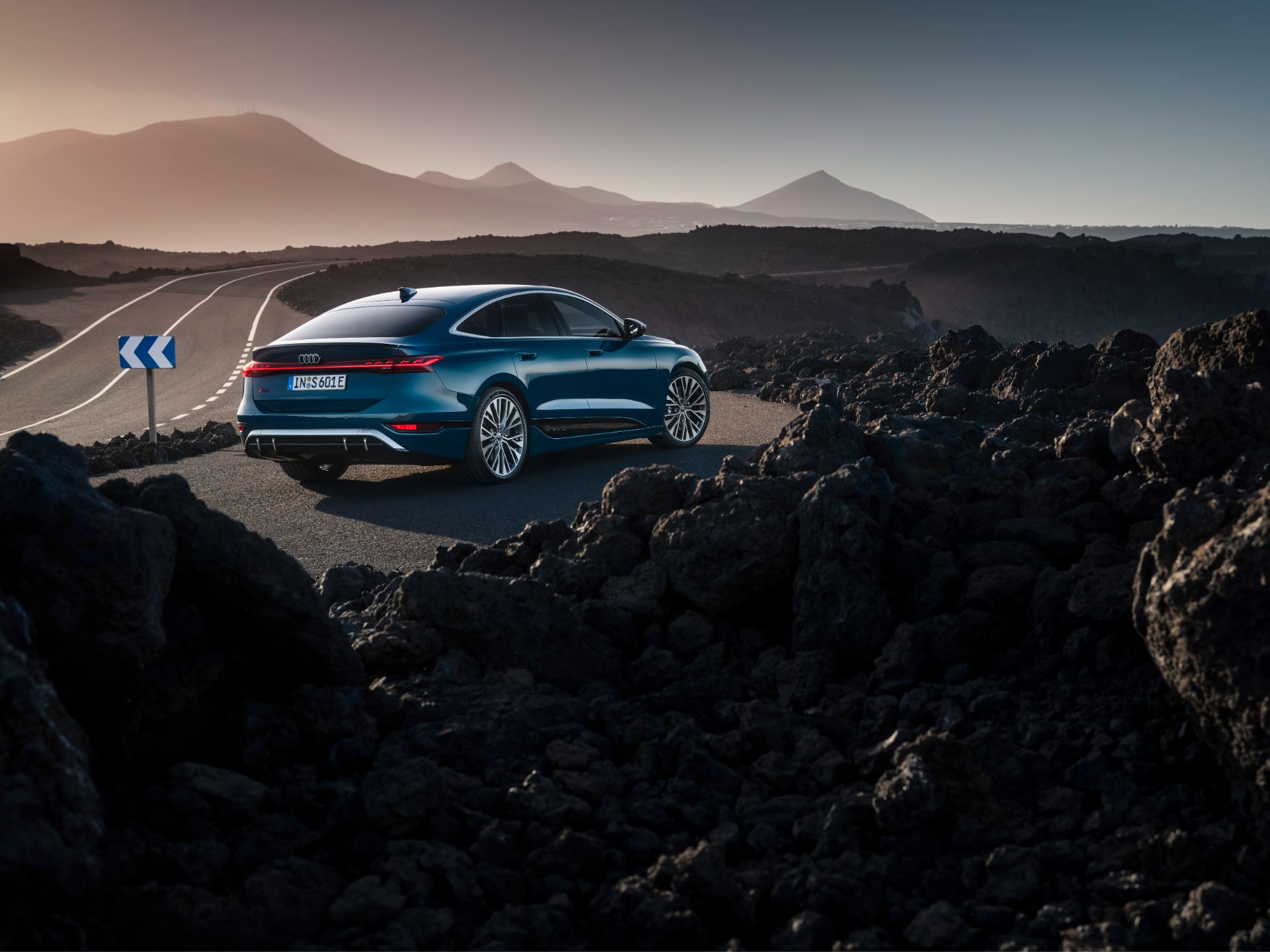 2026 audi s6 sportback e tron rear three quarter volcanic landscape teal
