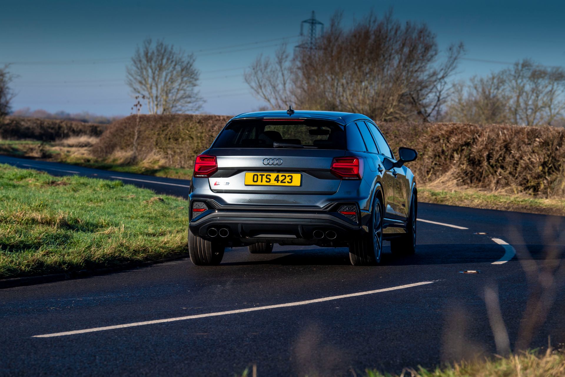 2025 audi sq2 driving rear country road grey