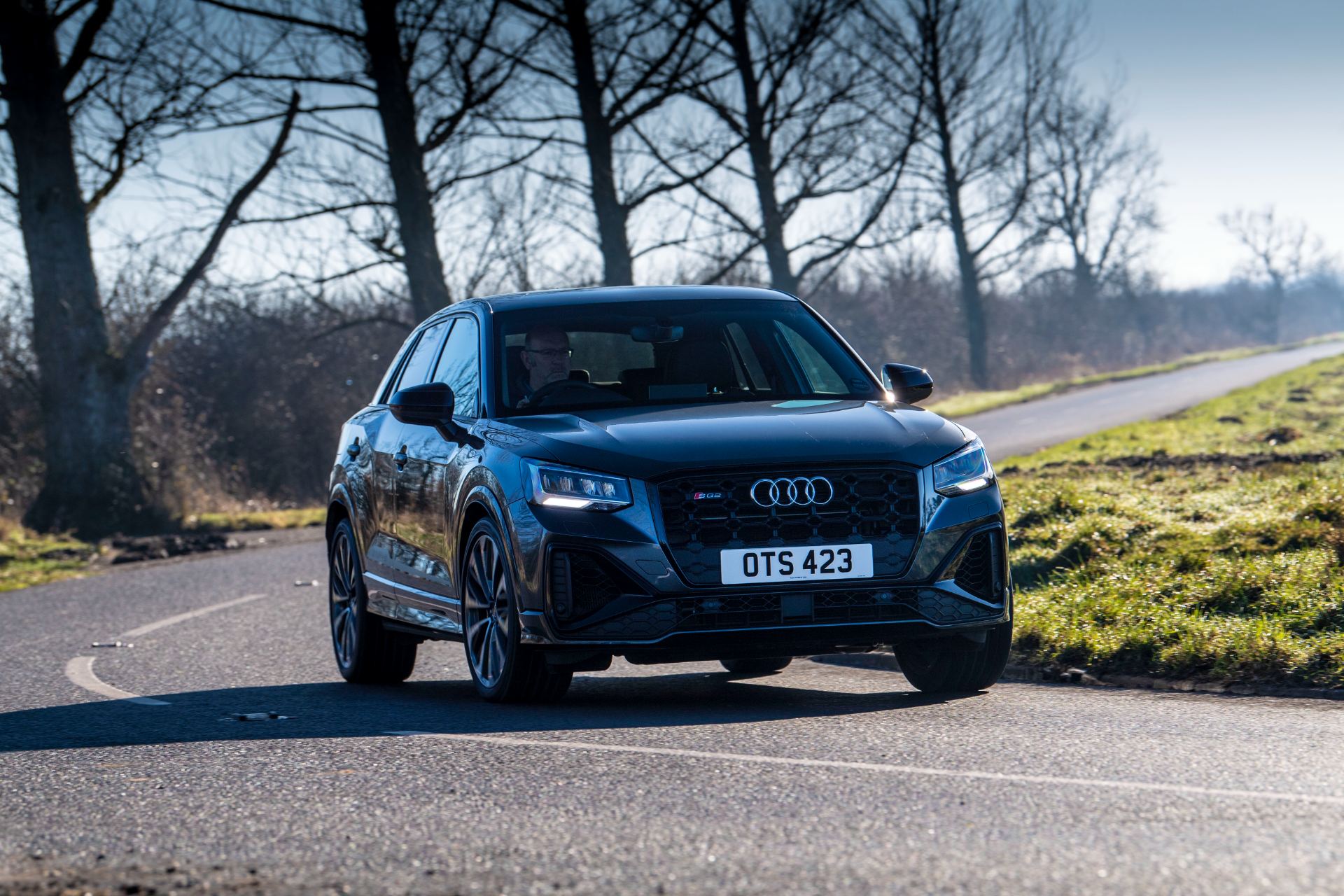 2025 audi sq2 driving front tree lined road grey