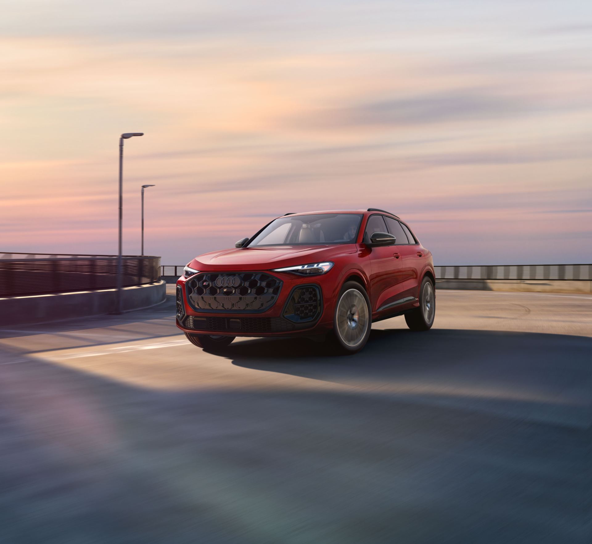 2026 audi sq5 driving front three quarter pier red