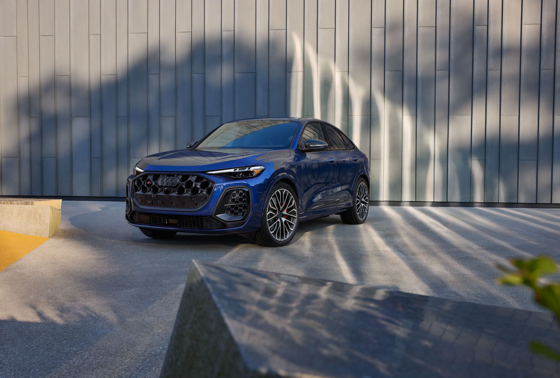 2026 audi sq5 sportback front three quarter wood wall blue
