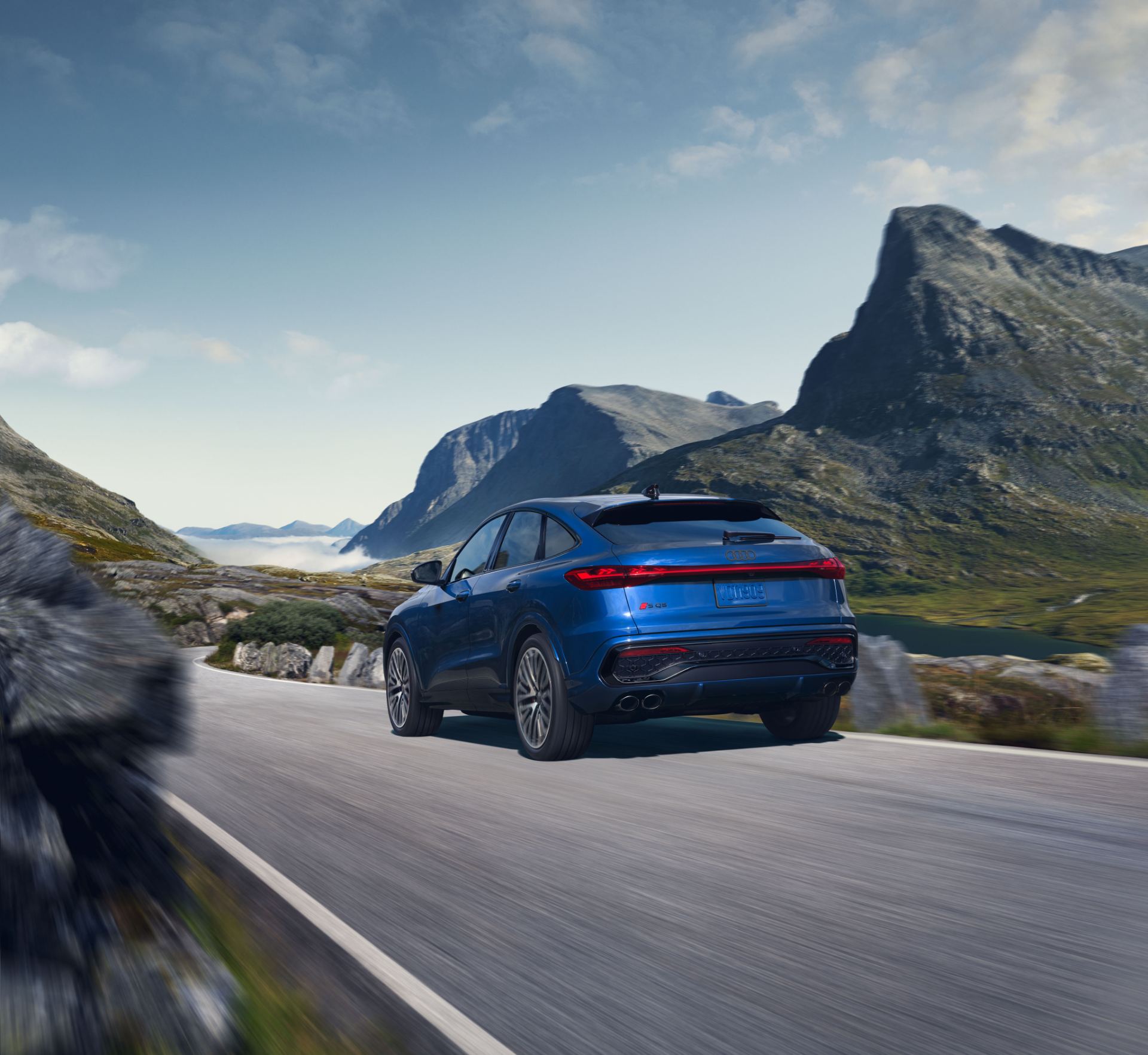2026 audi sq5 sportback driving rear mountain road blue