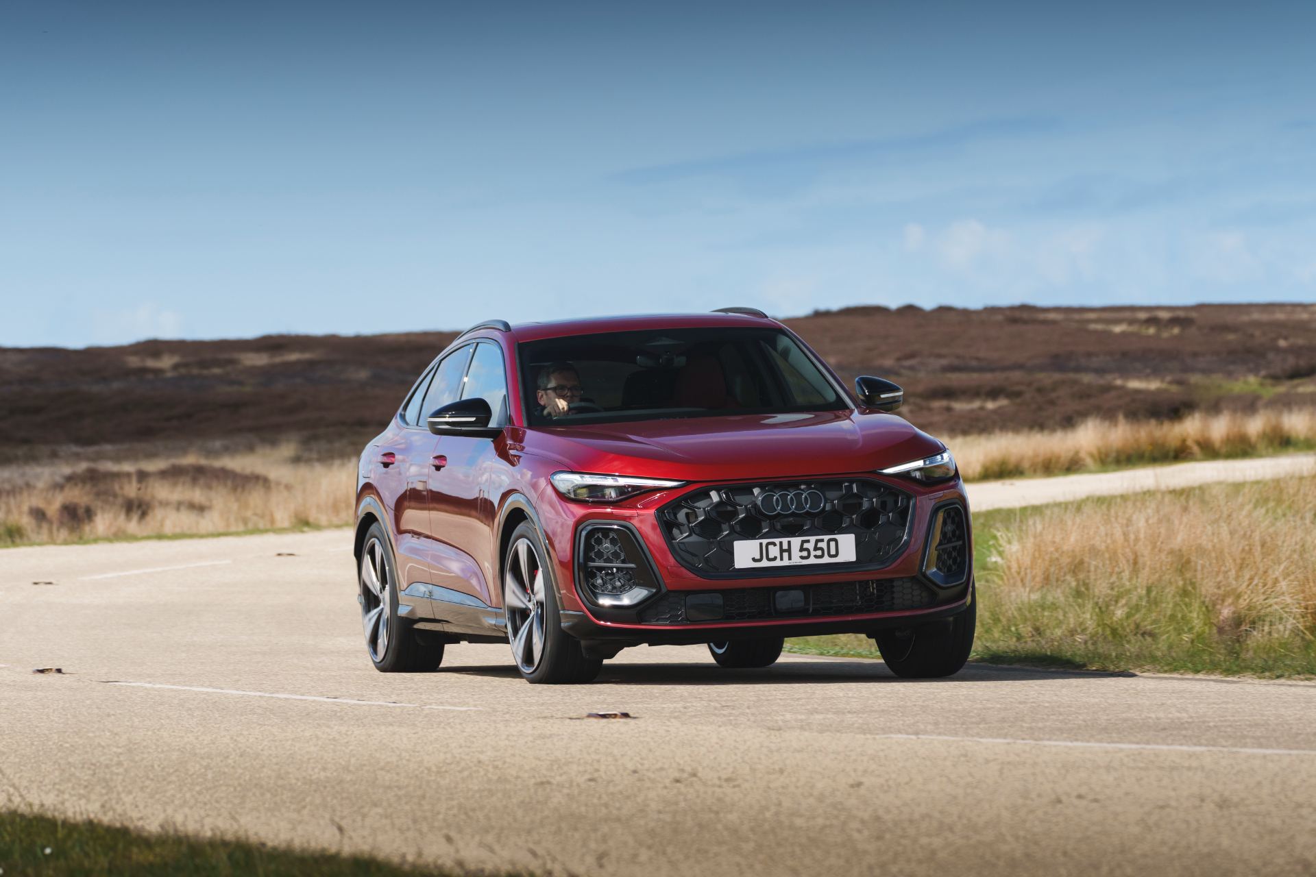 2026 audi sq5 sportback driving front three quarter cornering red