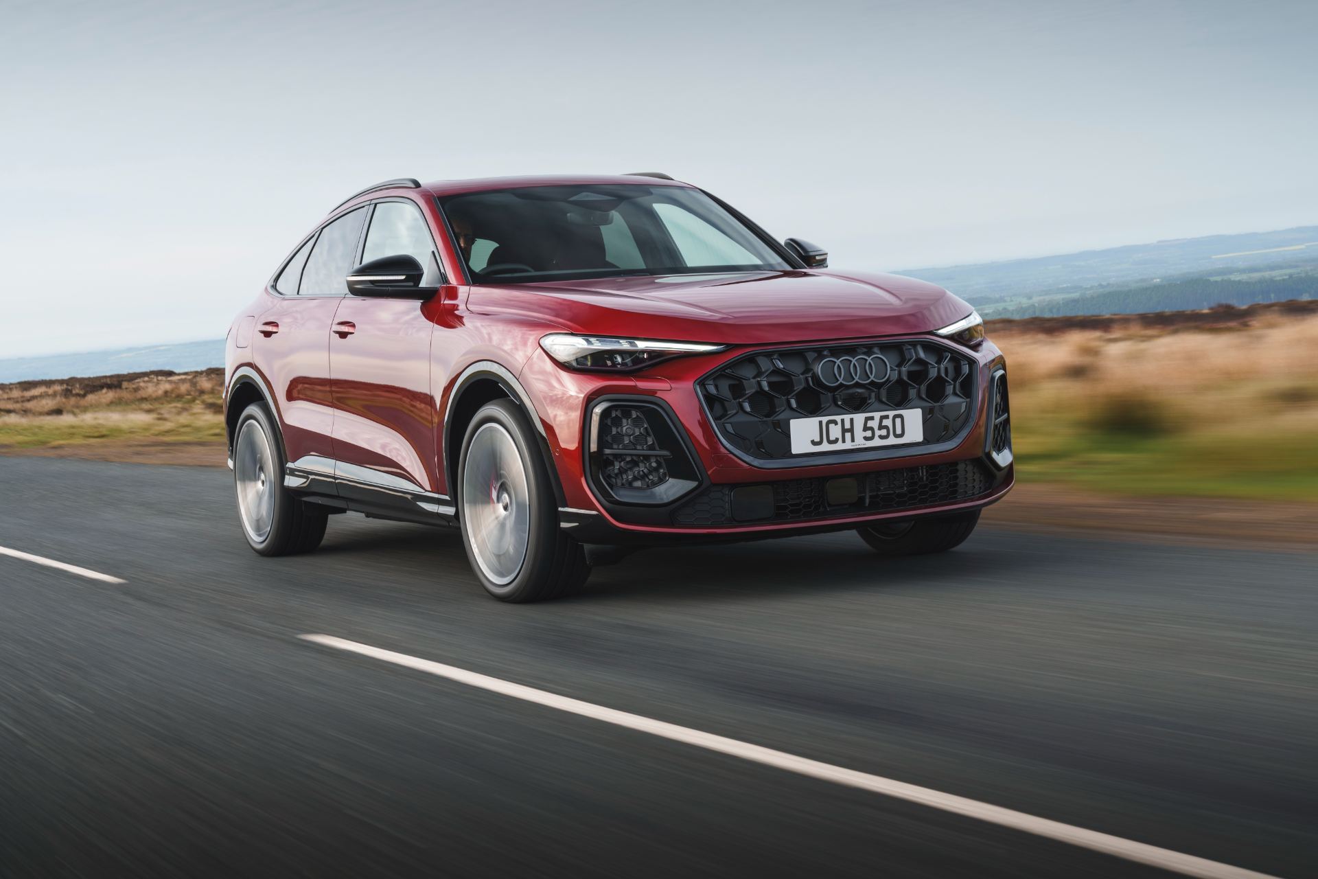 2026 audi sq5 sportback driving front three quarter red