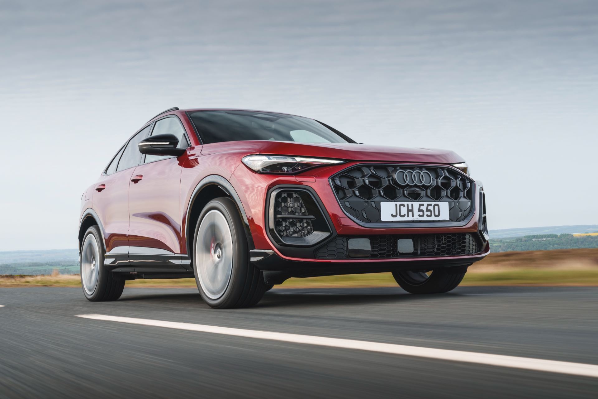 2026 audi sq5 sportback driving front three quarter low angle red