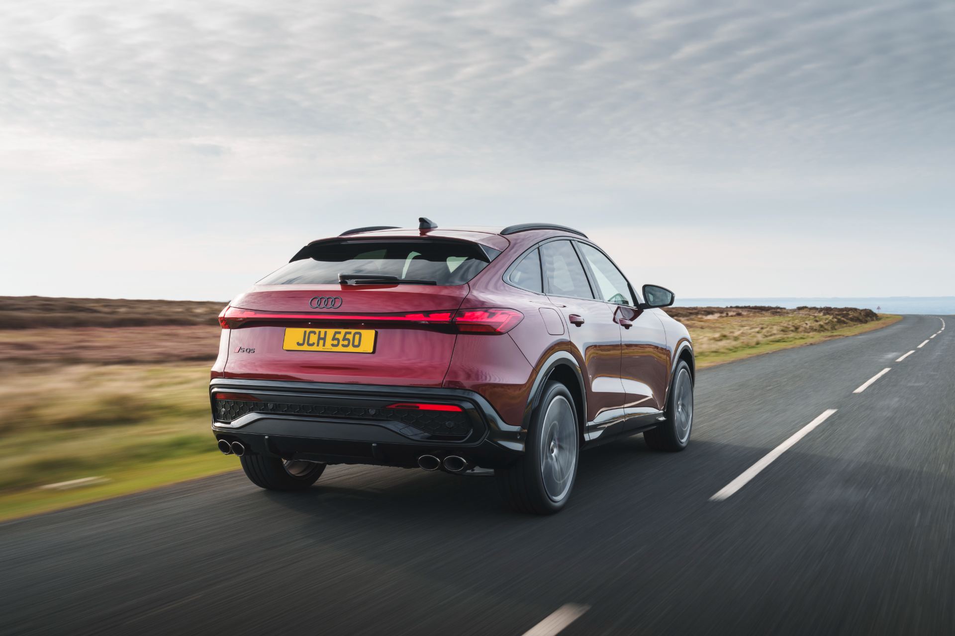 2026 audi sq5 sportback driving rear three quarter red