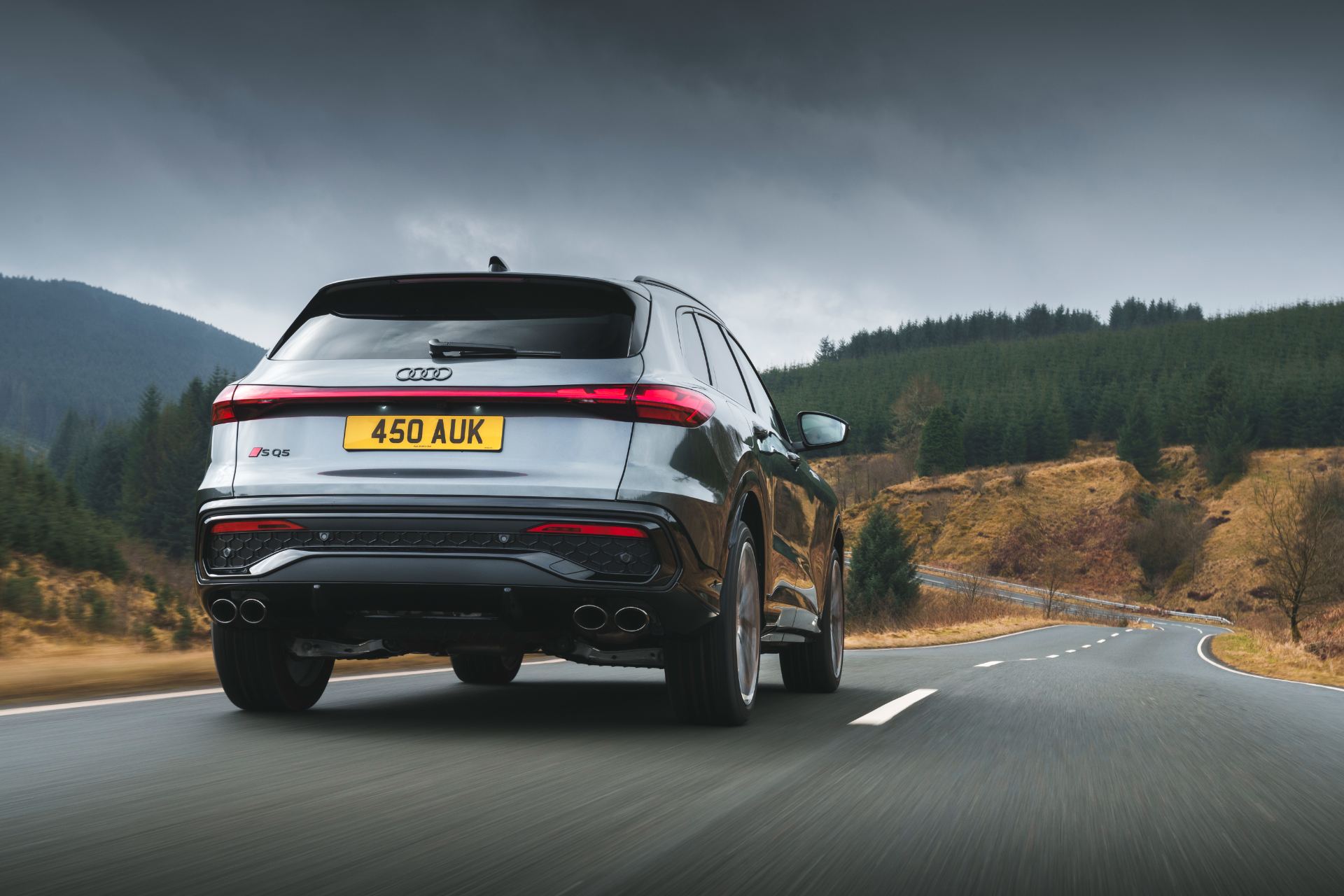 2026 audi sq5 driving rear three quarter grey