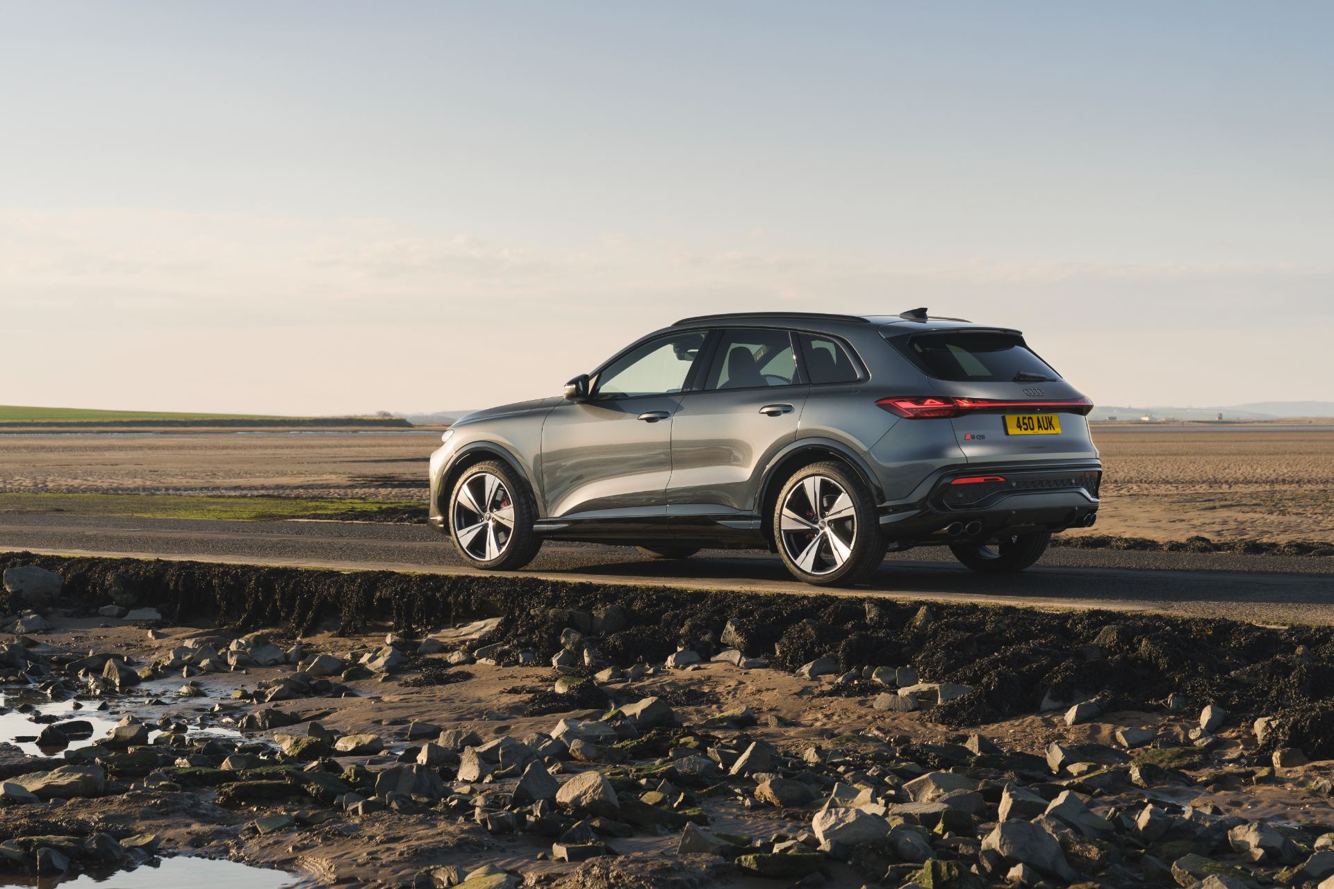 2026 audi sq5 rear three quarter coastal grey