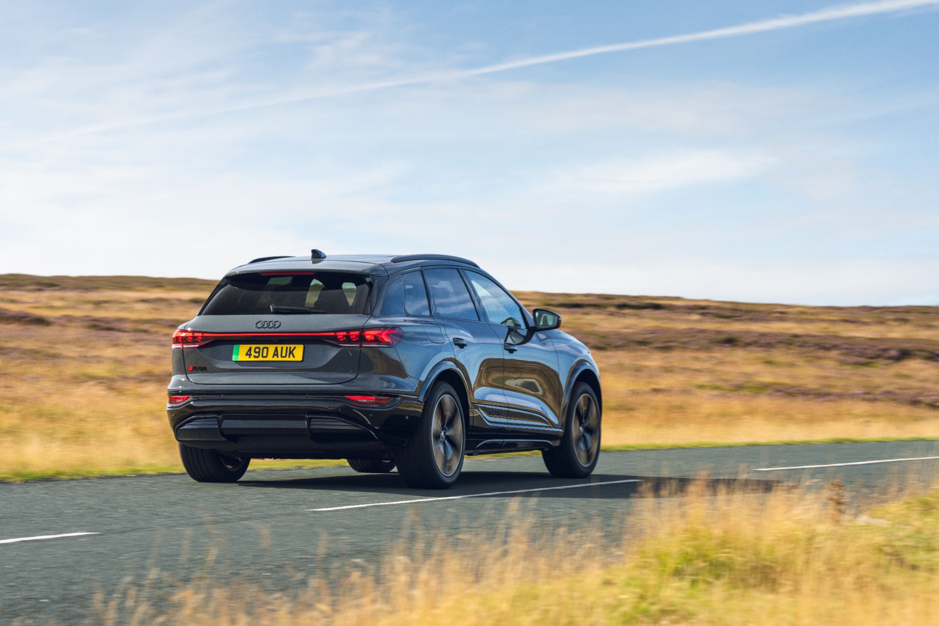 2026 audi sq6 e tron driving rear three quarter grey