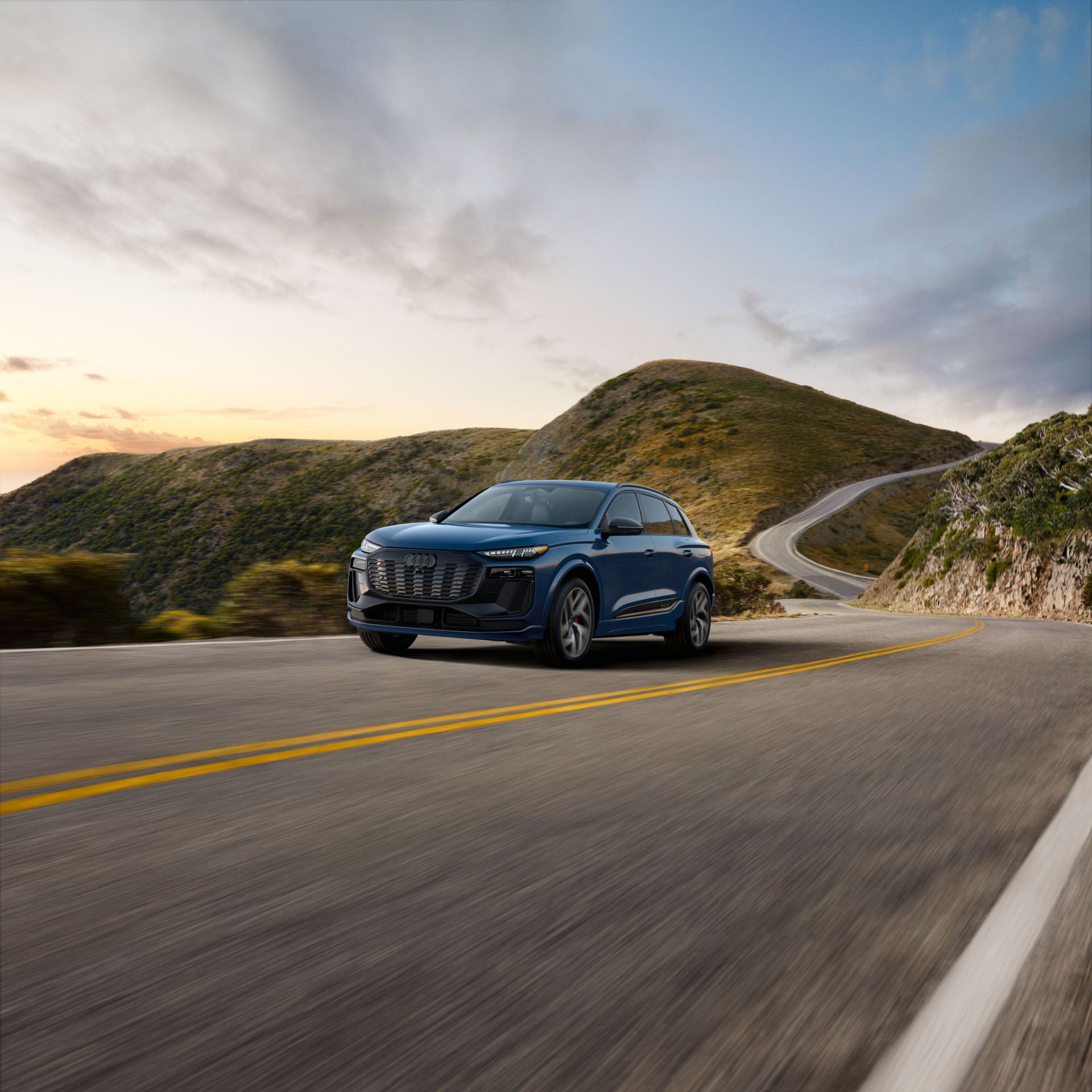 2027 audi sq6 e tron driving front canyon road blue
