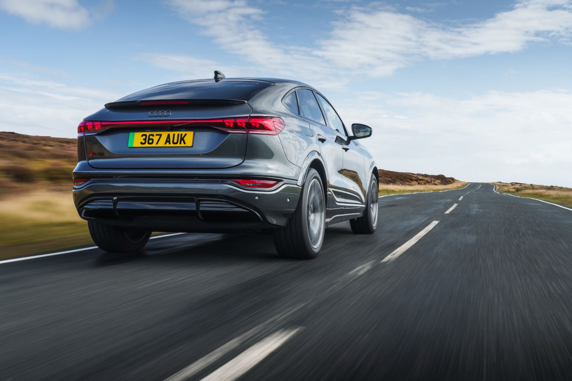 2026 audi sq6 sportback e tron driving rear low angle grey