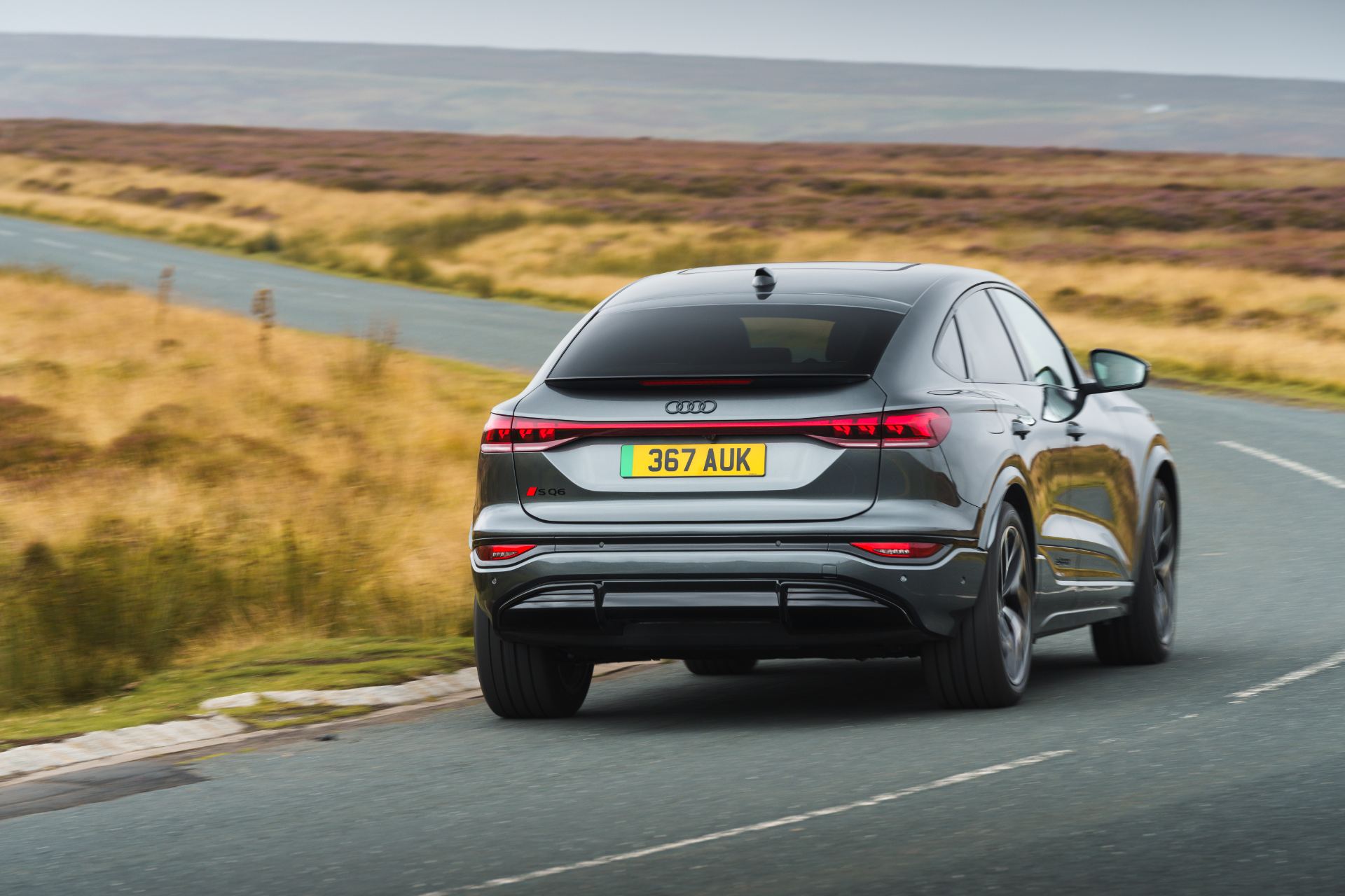 2026 audi sq6 sportback e tron driving rear three quarter bend grey