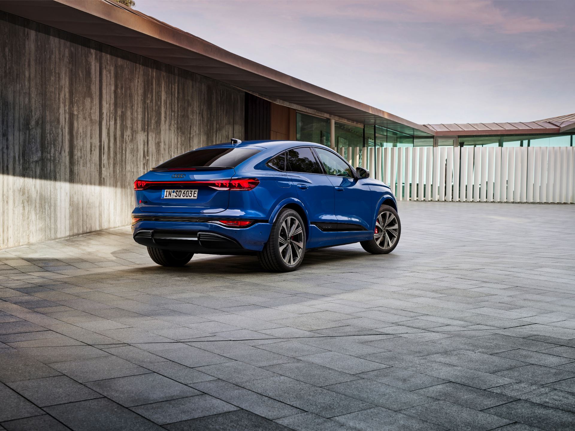 2027 audi sq6 sportback e tron rear three quarter villa courtyard blue
