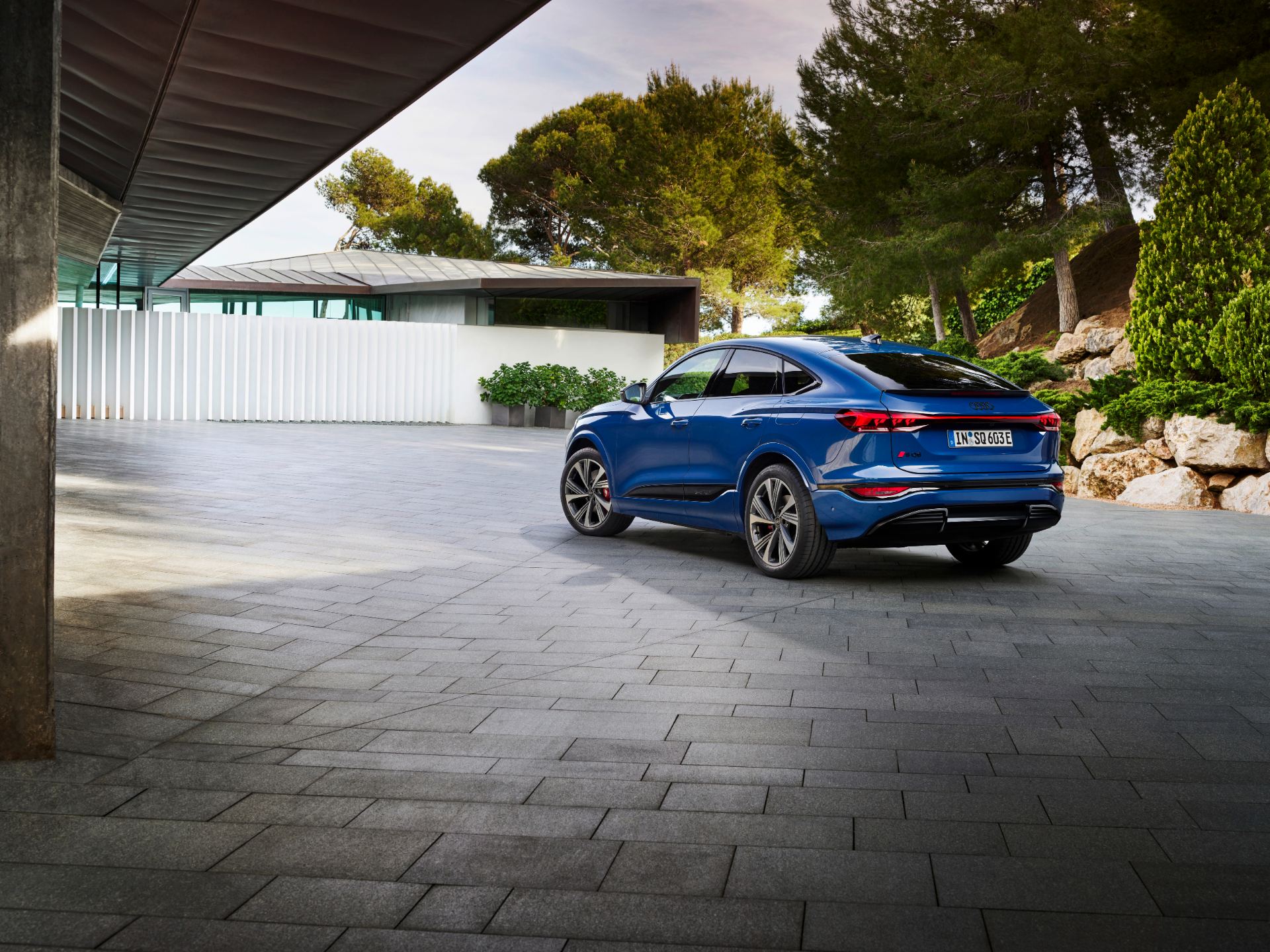 2027 audi sq6 sportback e tron rear three quarter courtyard wide blue