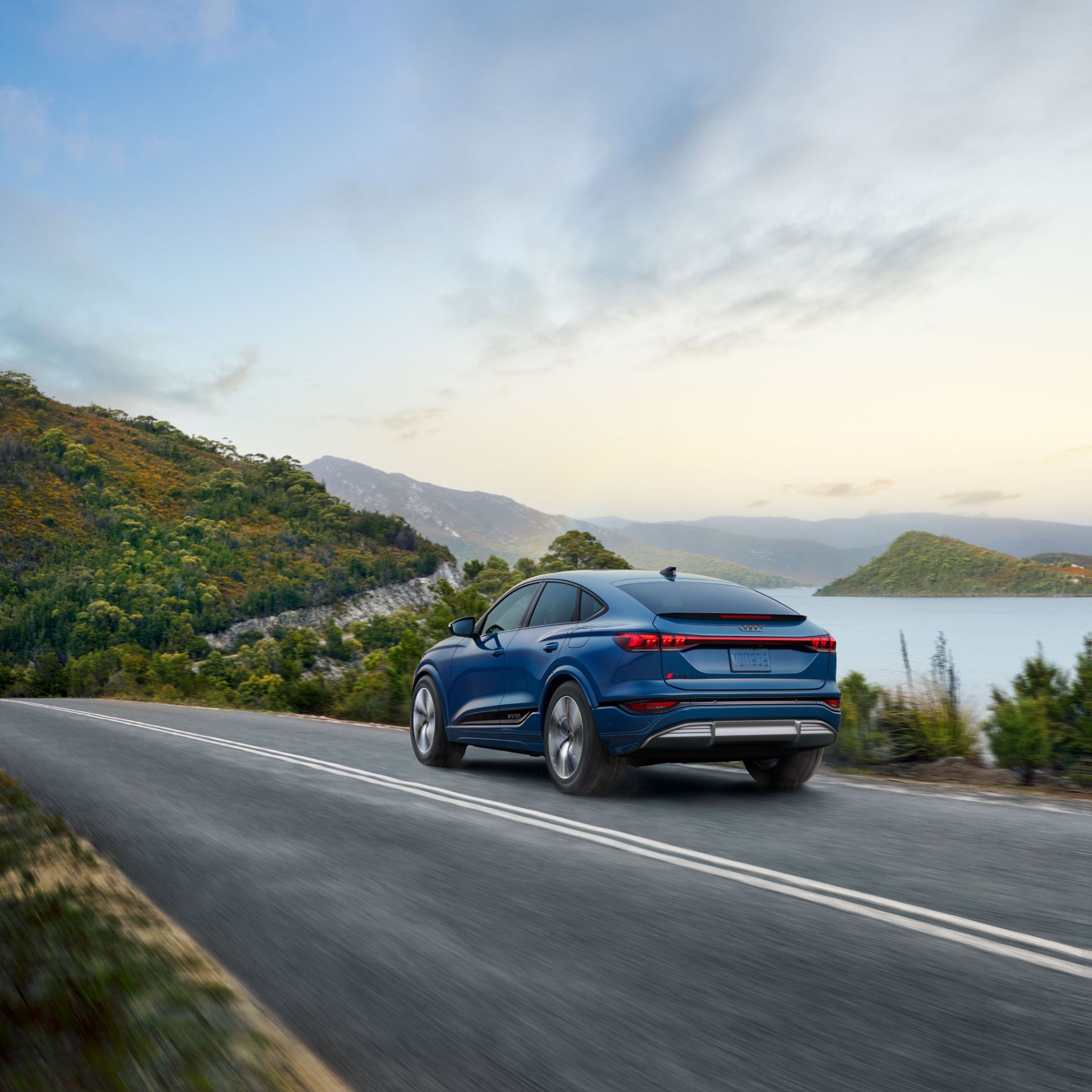 2027 audi sq6 sportback e tron driving rear three quarter lake road blue