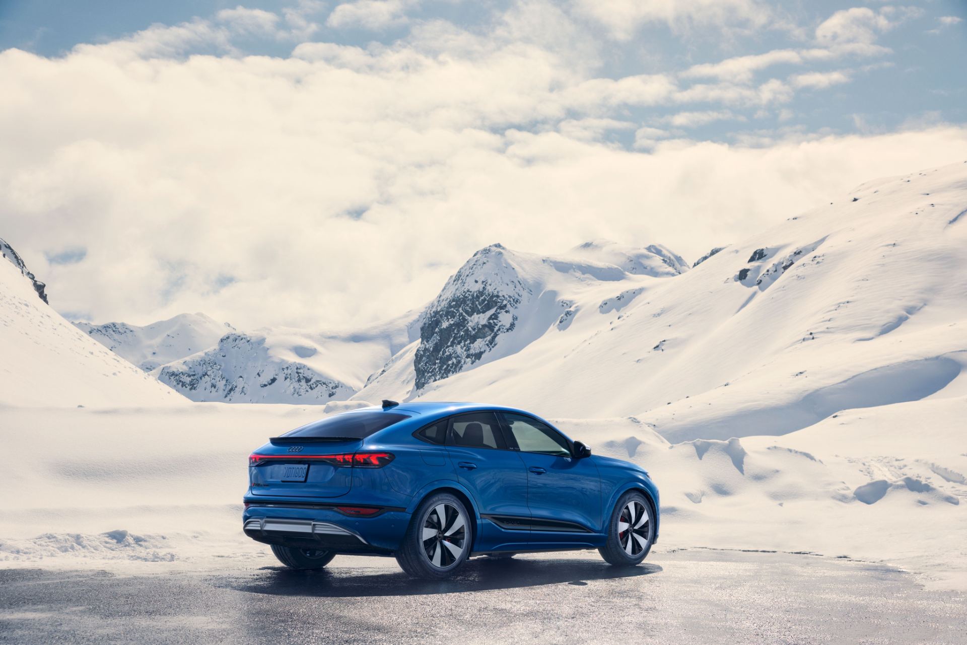 2027 audi q6 sportback e tron rear three quarter snow mountains grey