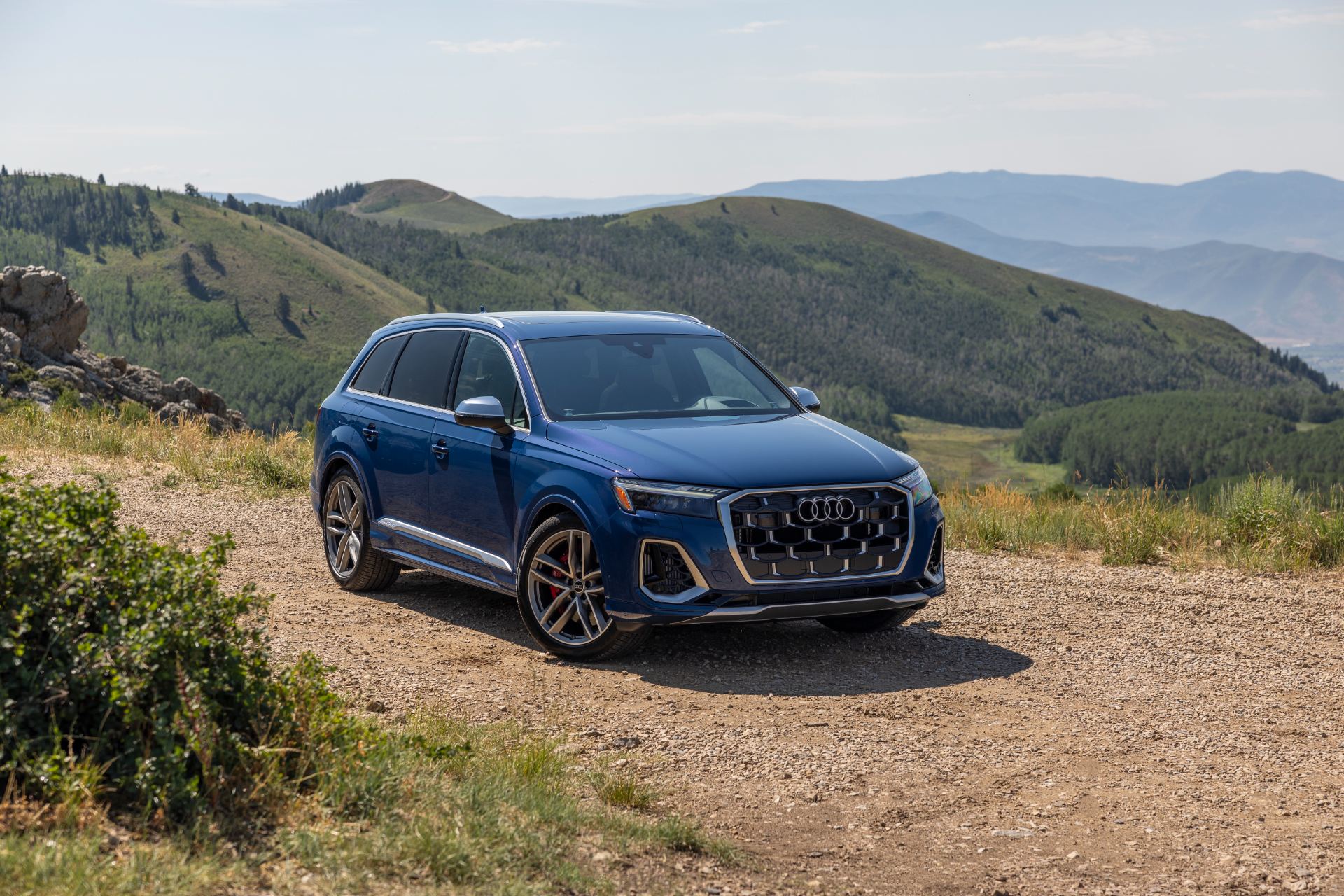 audi sq7 front three quarter mountain dirt road blue