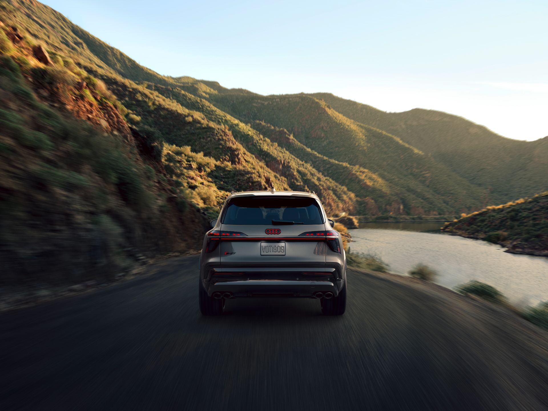 2027 audi sq7 driving rear canyon road grey