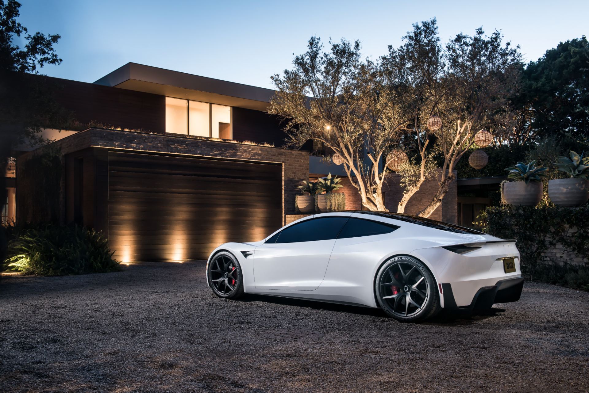 Rear three-quarter of the Roadster prototype showing the fastback roofline and integrated diffuser