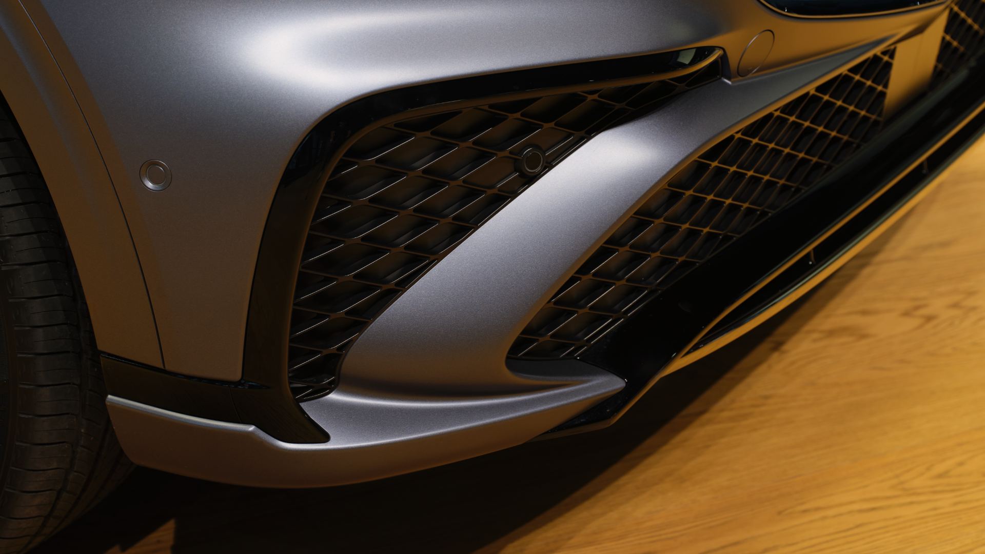 Close-up of the redesigned dual basket-weave grille and slim quad-lamp headlights