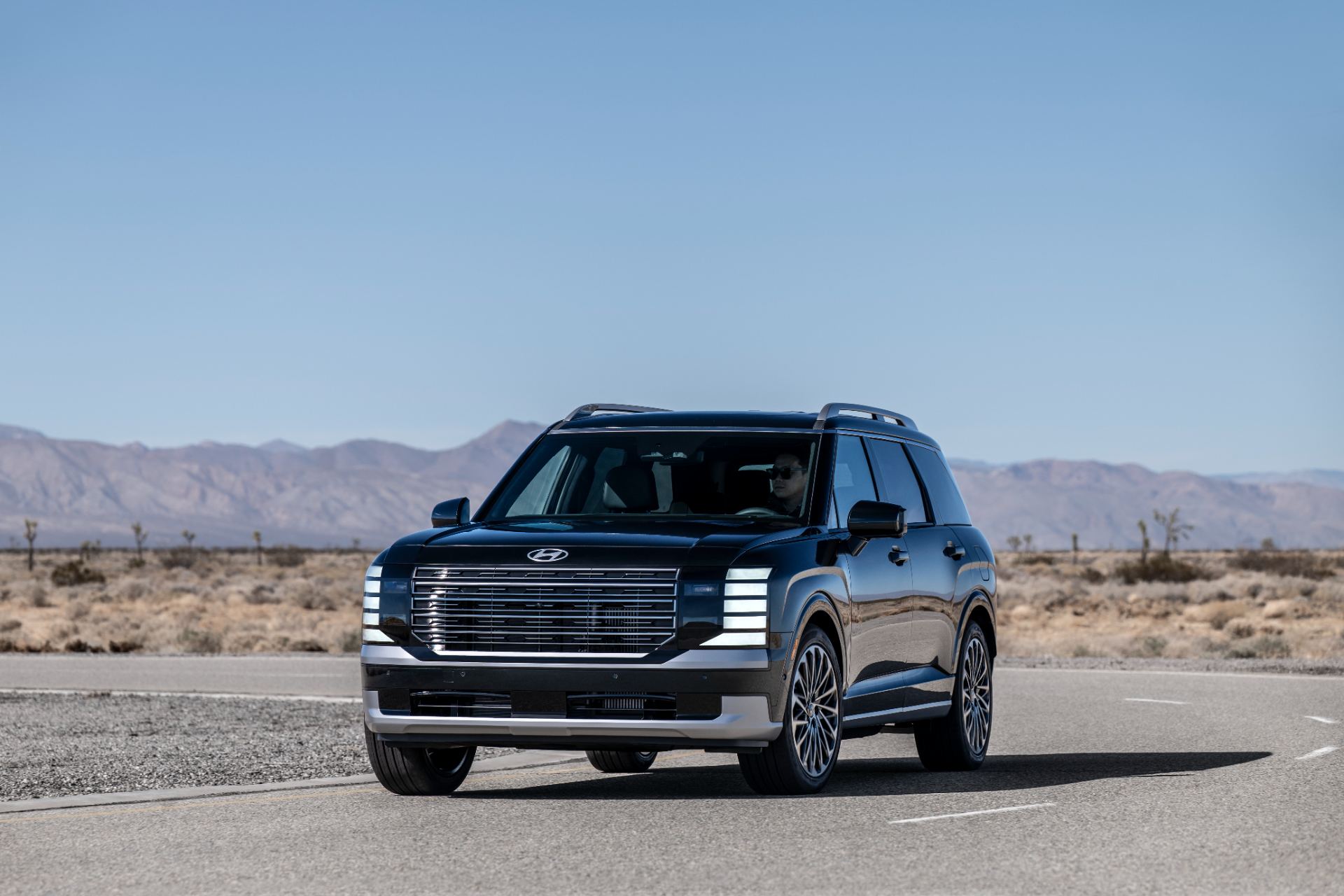 Front three-quarter exterior of the all-new 2026 Hyundai Palisade in a light metallic finish, official press photo on location