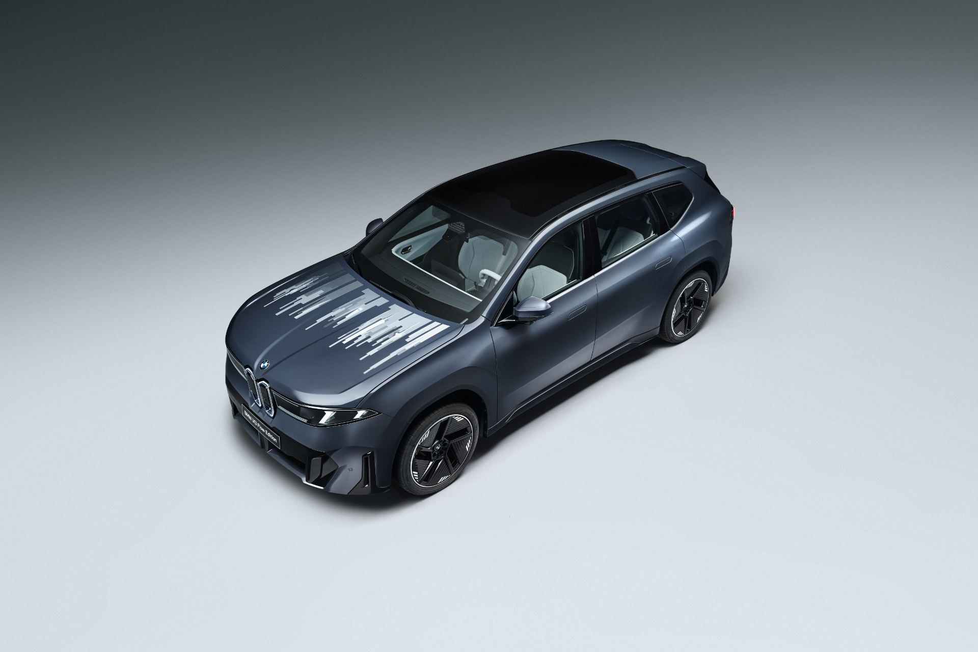 Rear three-quarter view highlighting the flush tailgate and full-width lower diffuser