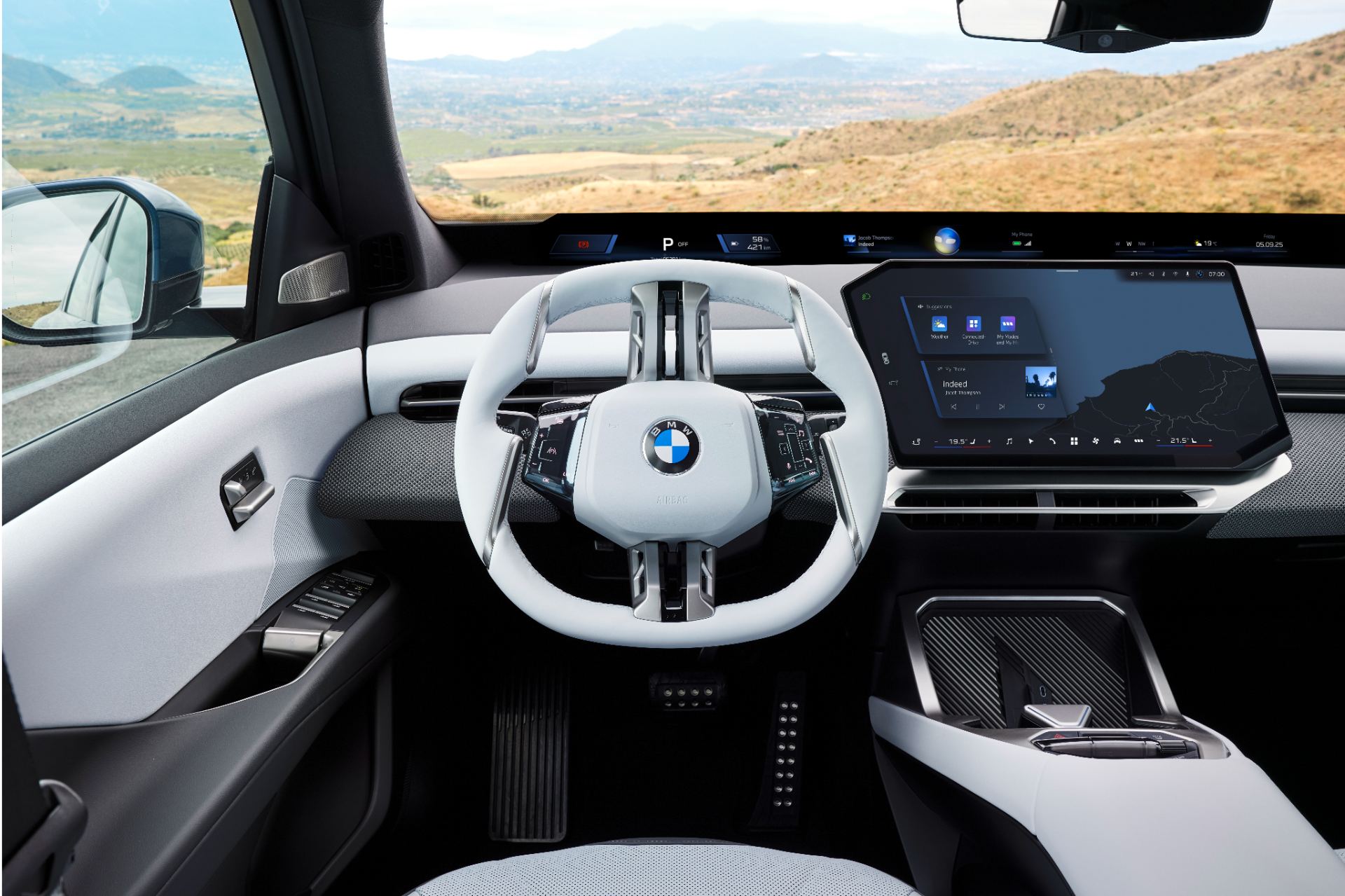 Dashboard and cockpit showing the full-width BMW Panoramic Vision display and free-cut central touchscreen