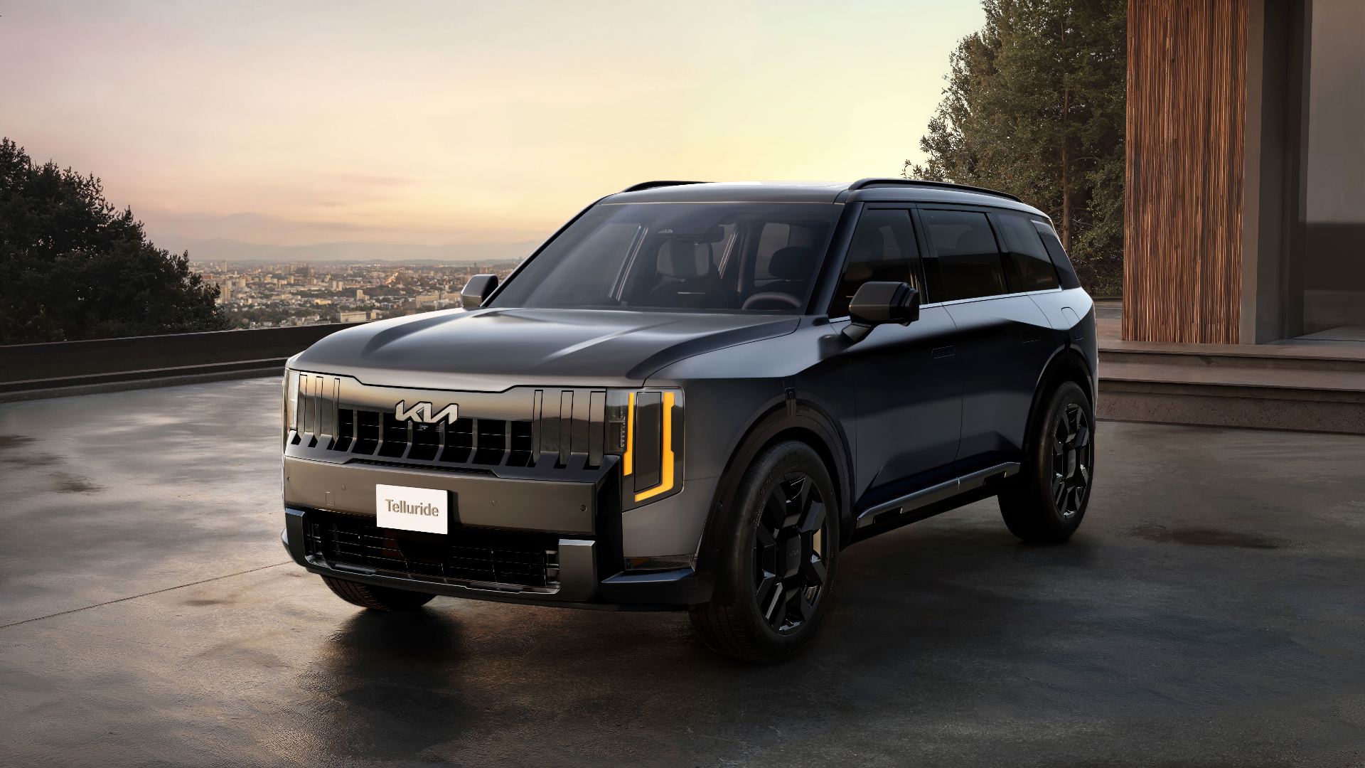 Front three-quarter exterior of the 2027 Kia Telluride X-Pro in a dark green metallic on a gravel setting, official Kia press photo