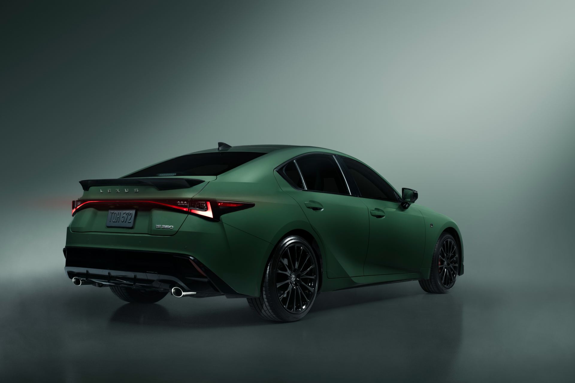 Rear three-quarter highlighting the Envious green paint depth and black wheels