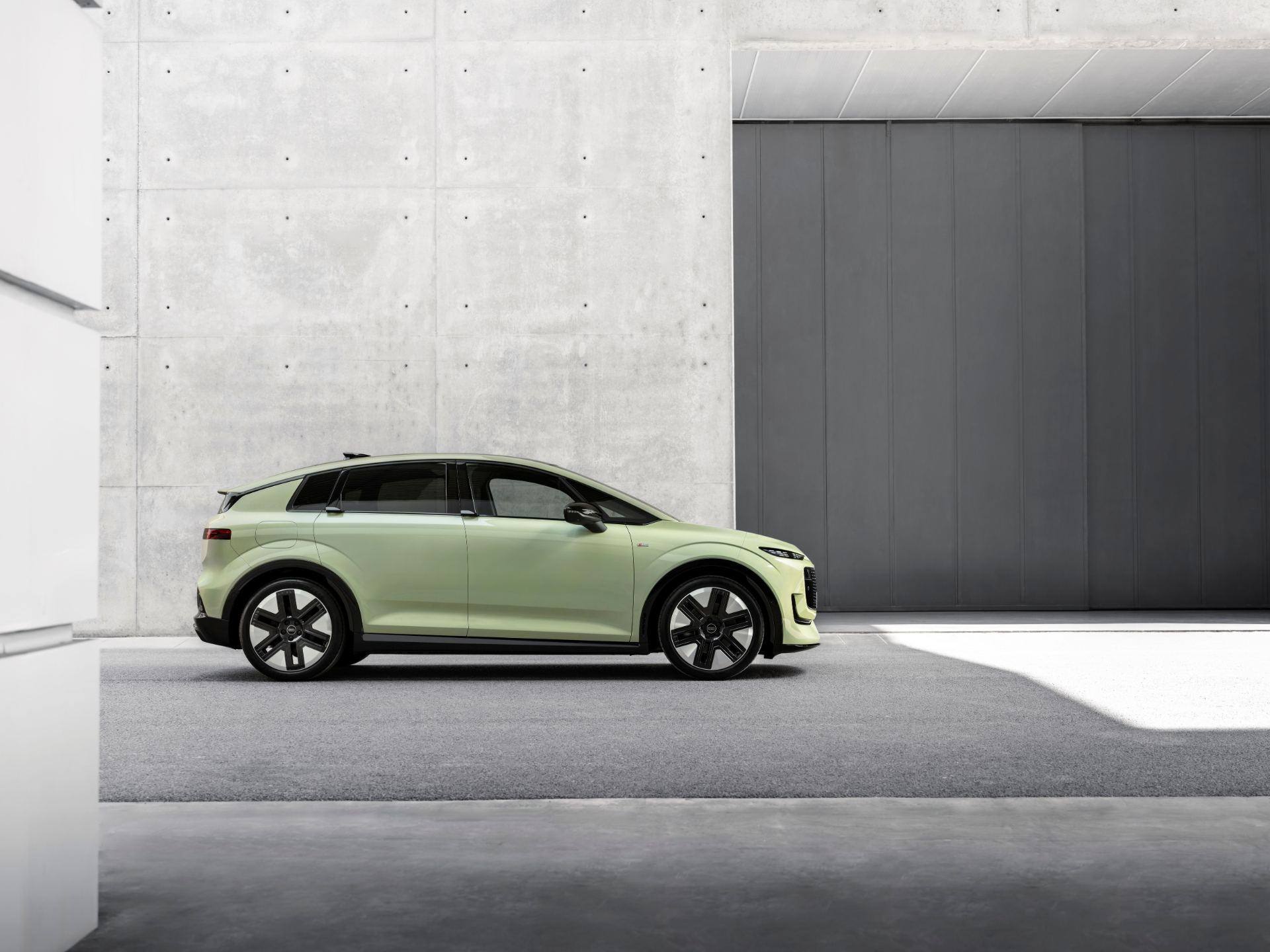 Side profile highlighting the flush electric door handles and aero wheels